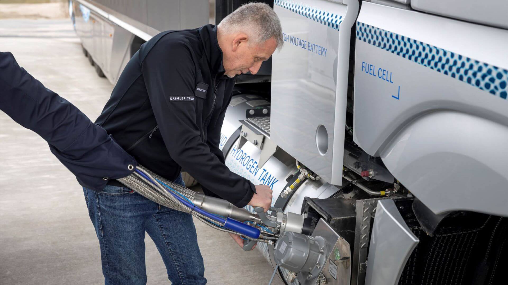 Man refuelling hydrogen truck