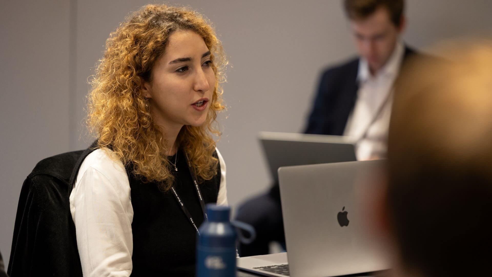 Photo of Esin Serin, Policy Fellow, Grantham Research Institute on Climate Change and the Environment, LSE, sat at table with laptop in front of her