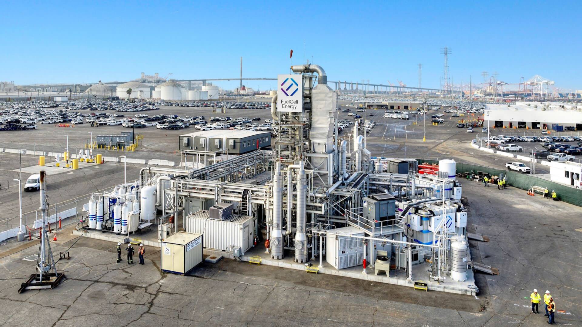 Aerial overview of industrial plant buildings, pipework and tanks