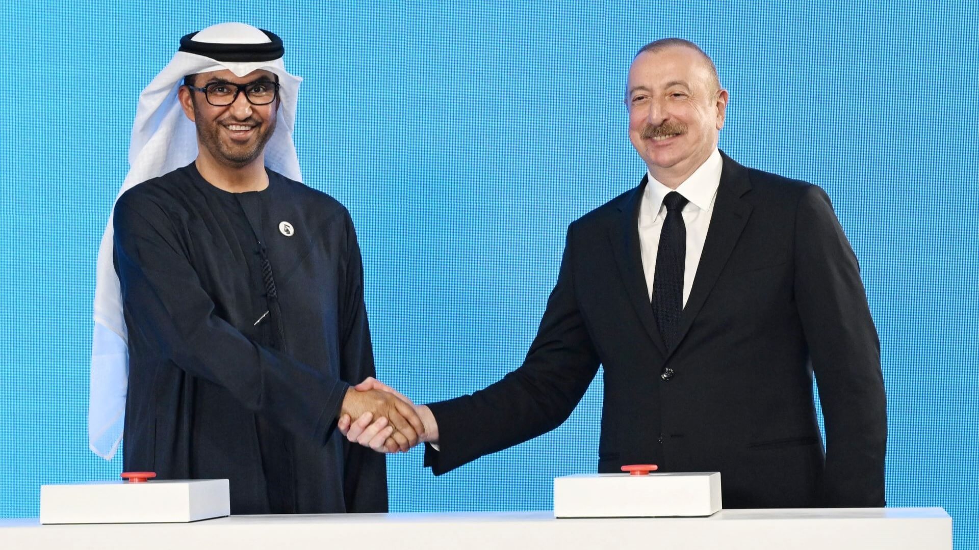 Dr Sultan Al Jaber and Ilham Aliyev shaking hands during ceremony