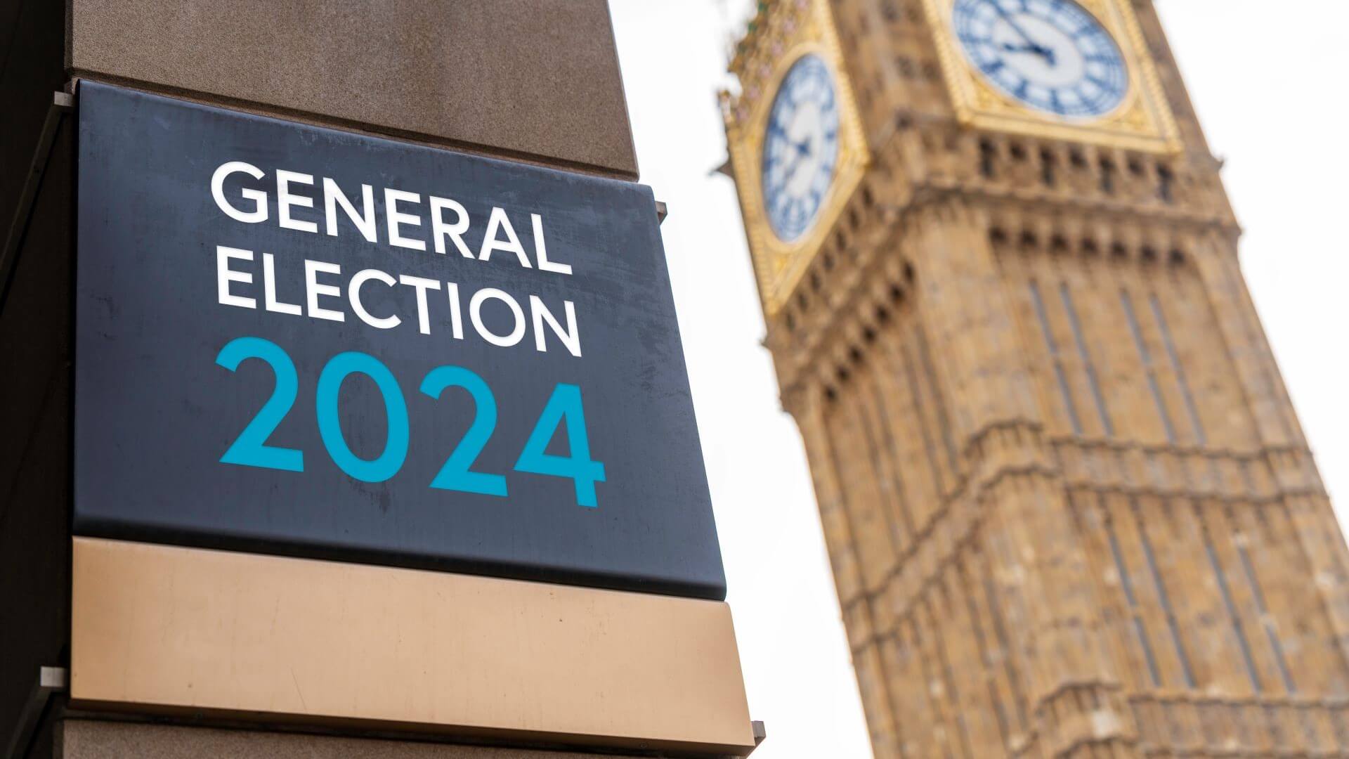 Billboard with General Election 2024 written on it to left of photo, with blurred image of Big Ben in the background
