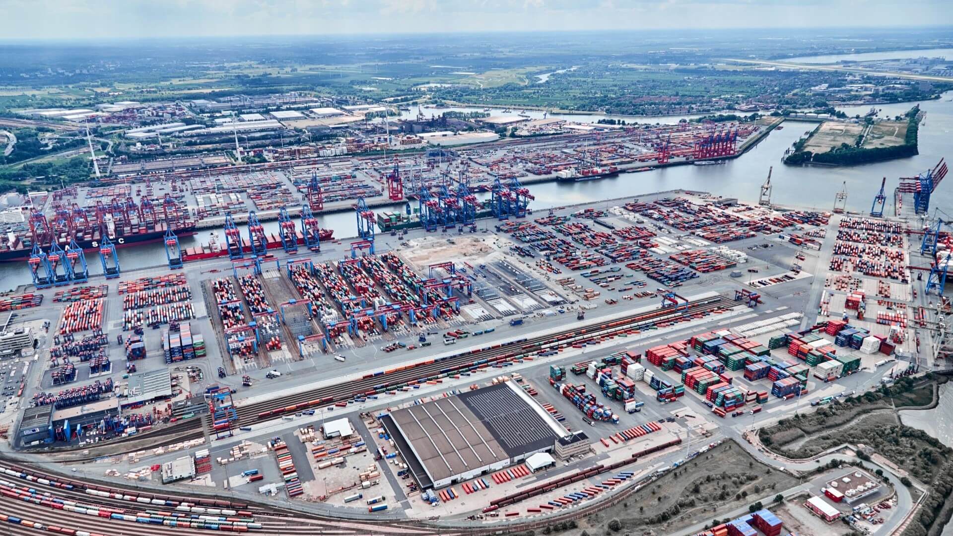 Aerial overview of Hamburg port, showing port infrastructure, buildings, containers and cranes
