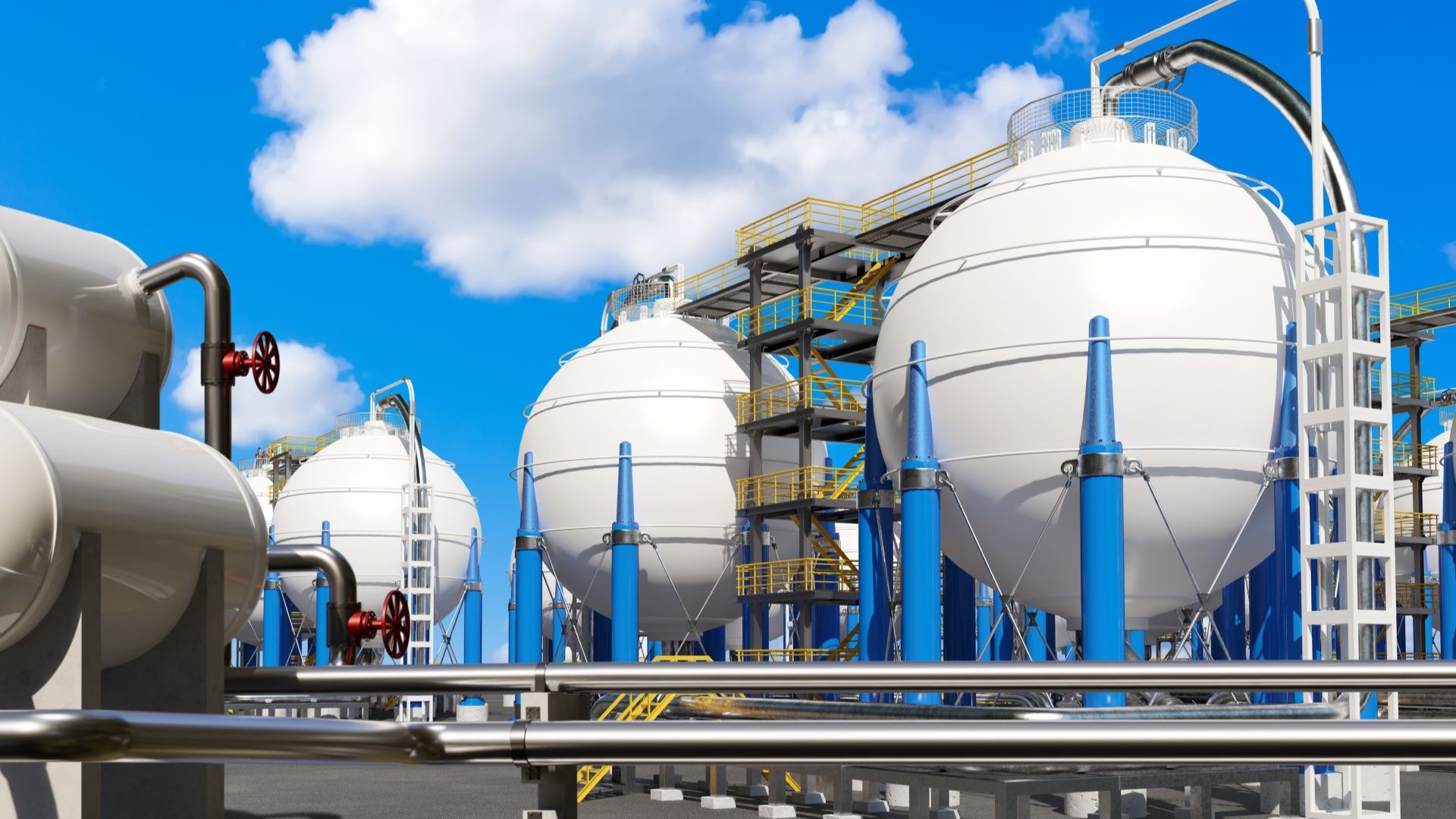 Liquified gas storage tanks against a blue sky