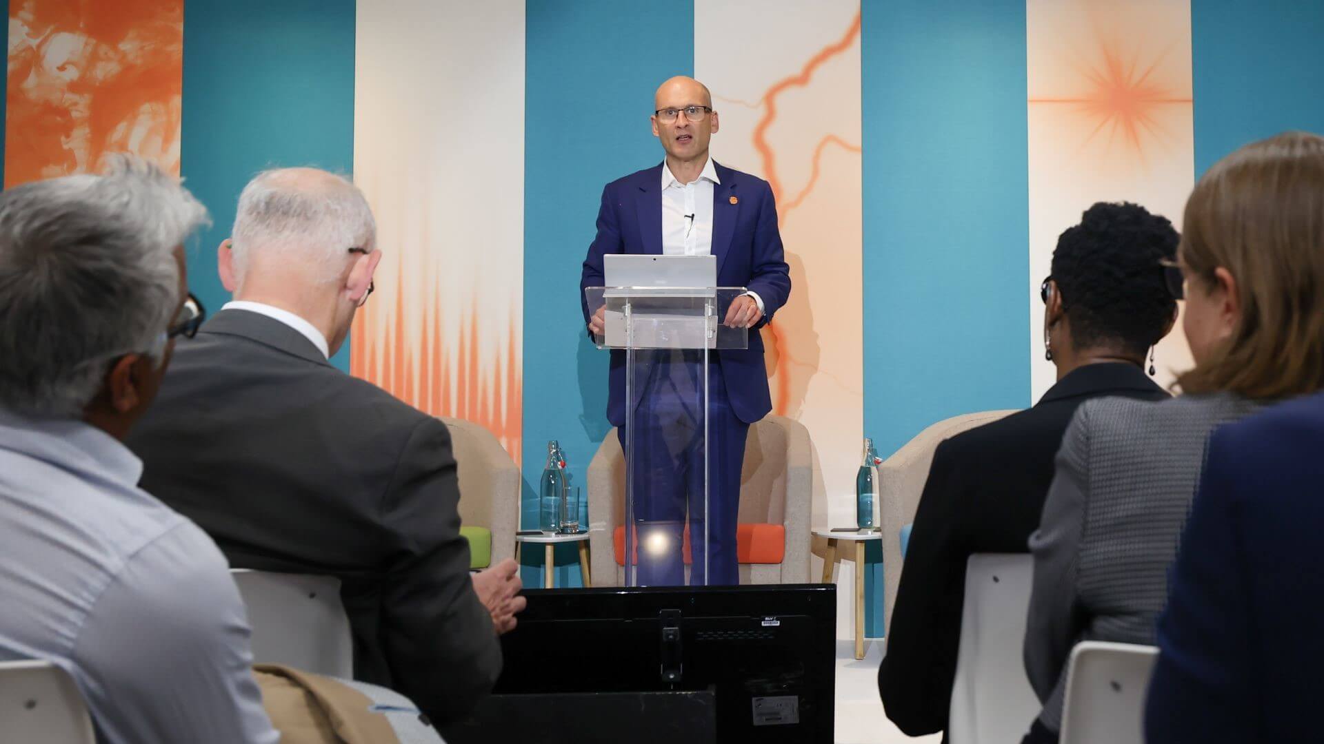 Nick Wayth standing at lectern, talking to an audience before him