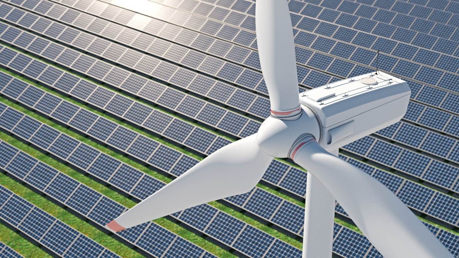Close up of wind turbine with rows of solar panels behind