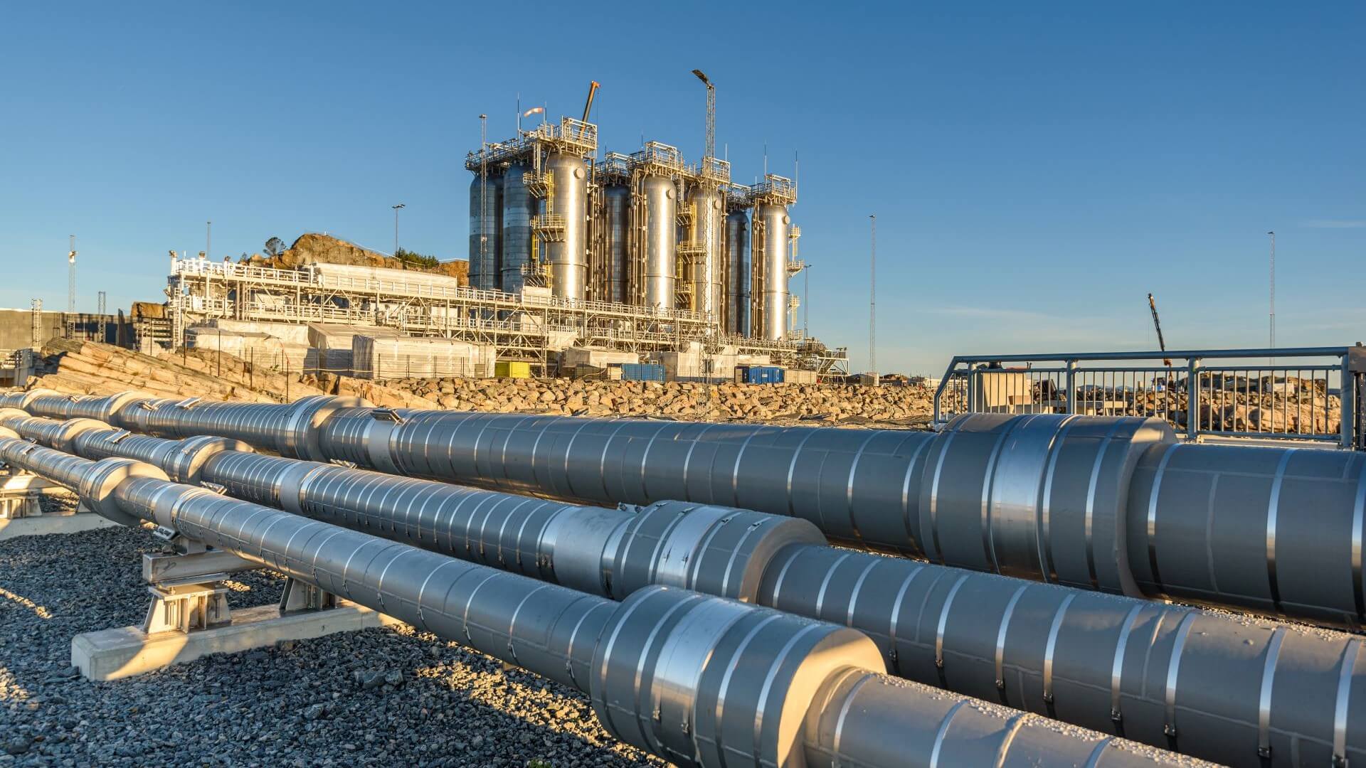 Storage vessel tanks in background with pipework in foreground