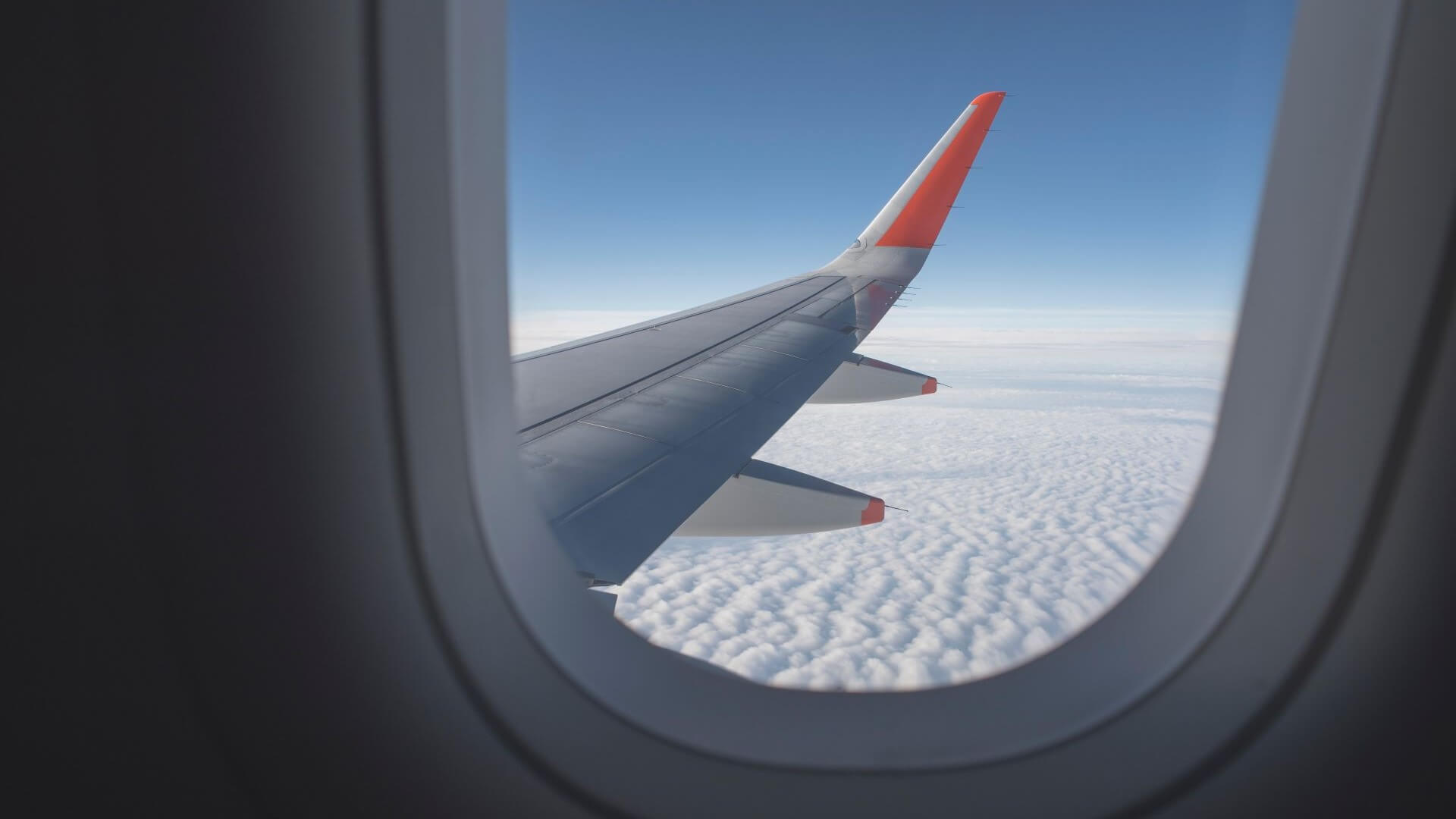 View from aircraft window of wing during flight