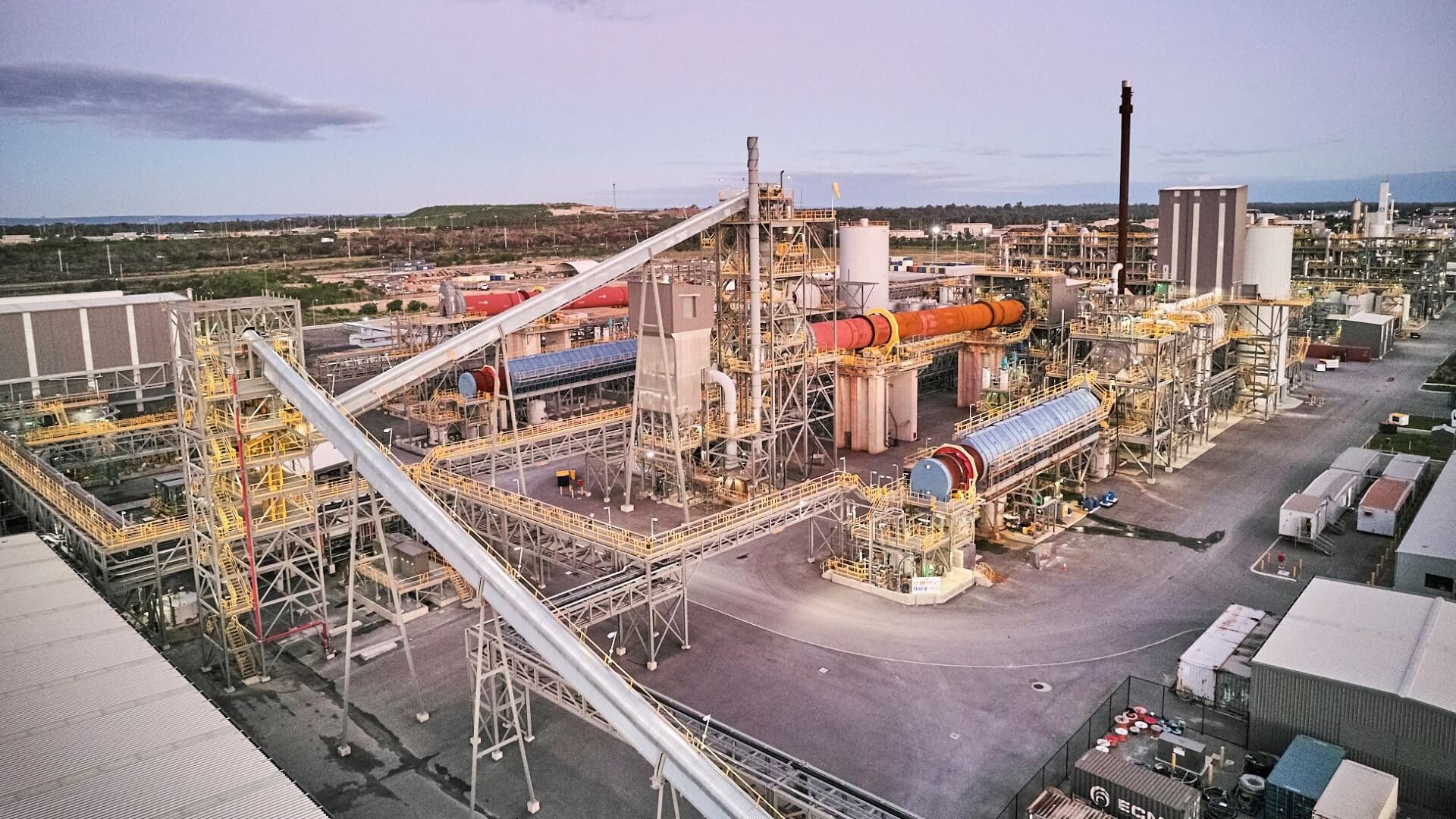 View over industrial plant, showing pipework, tanks and stacks