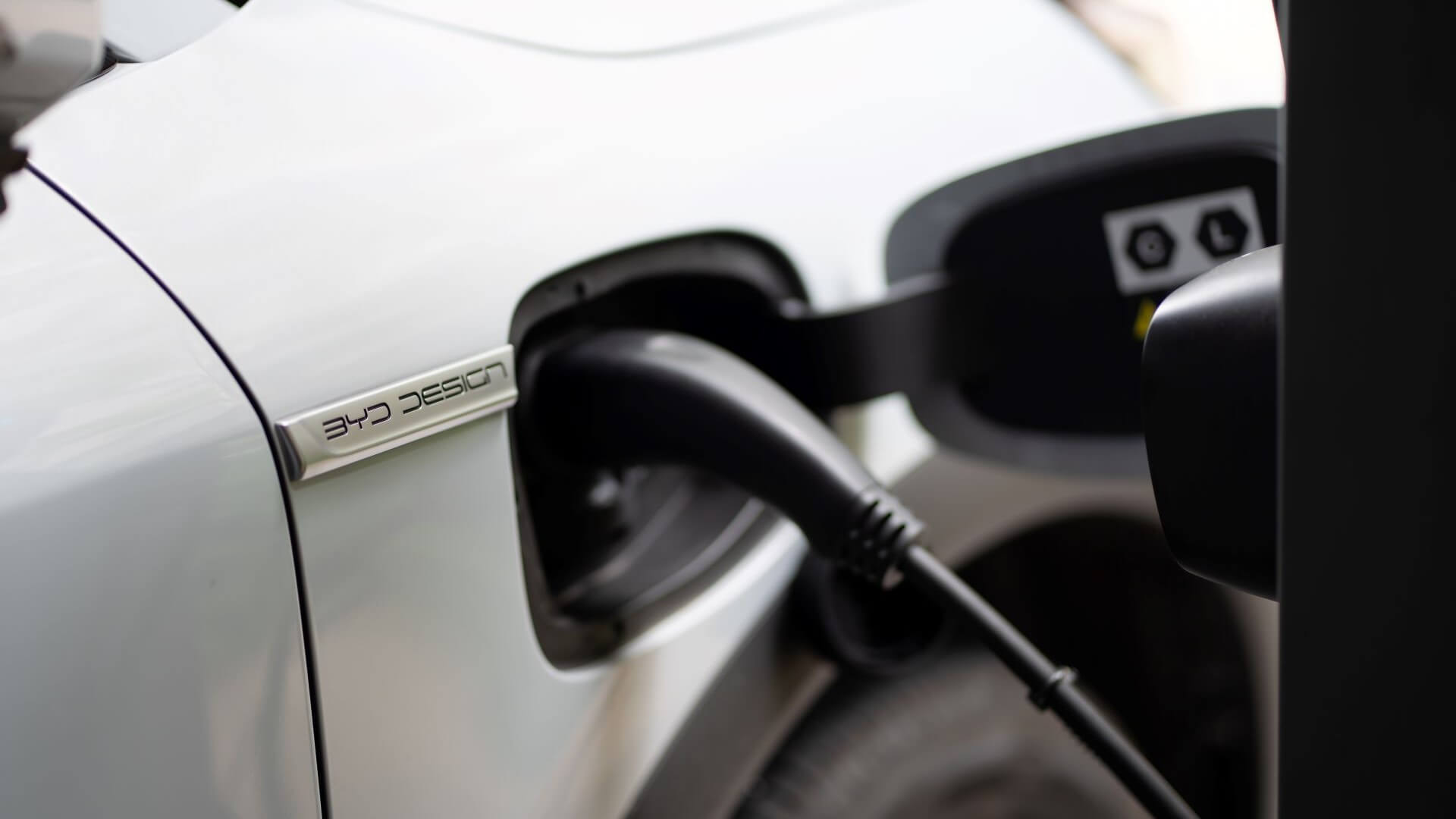 Close up of charger plugged into EV