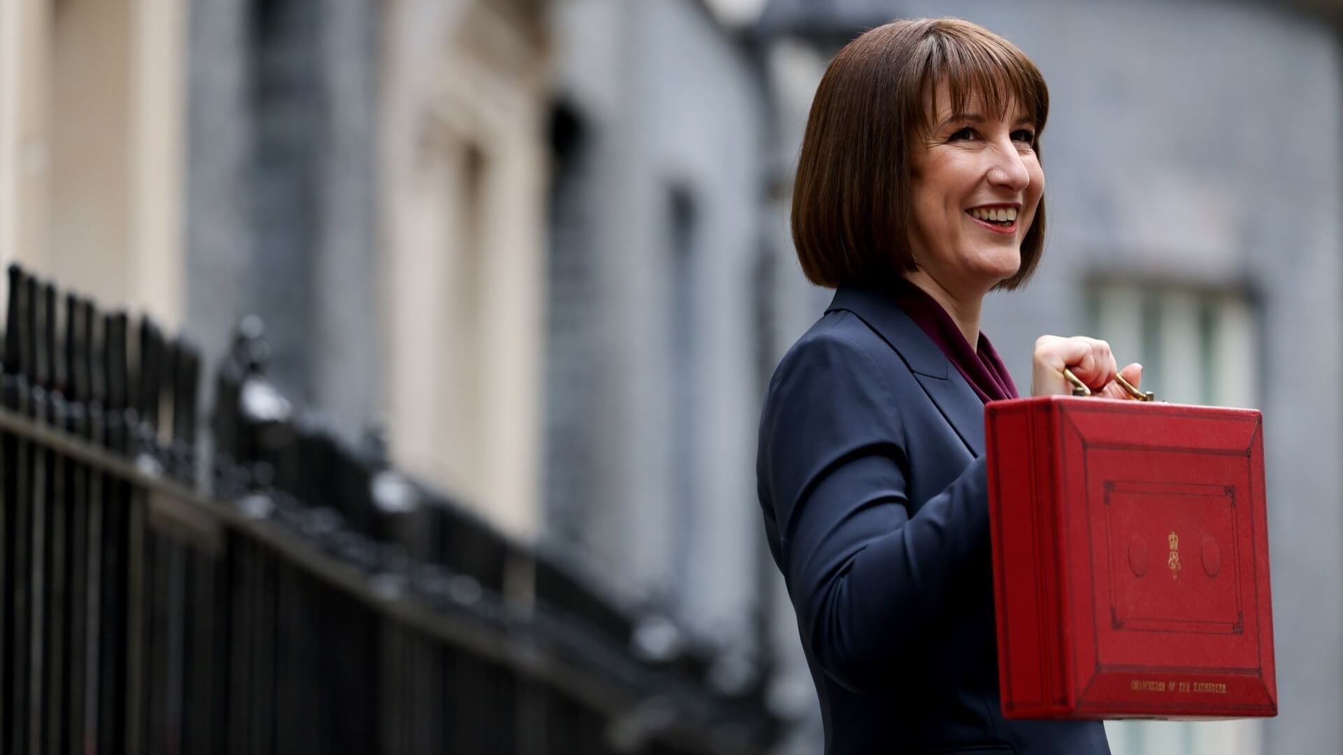 UK Chancellor Rachel Reeves lifting budget box in Downing Street