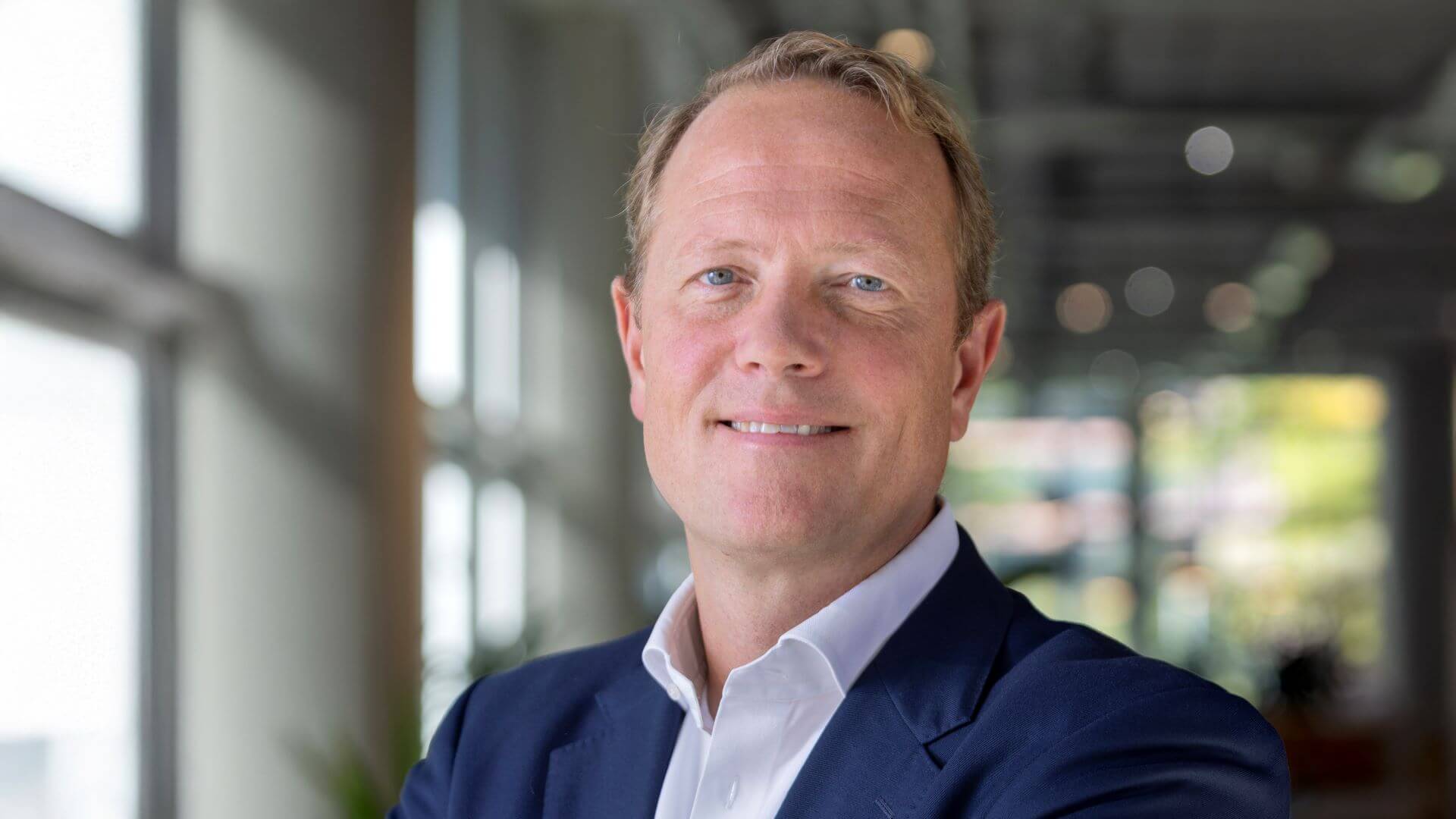 Head and shoulders photo of Michiel de Haan, Global Head of Energy Sector, ING, inside room with windows to right and behind