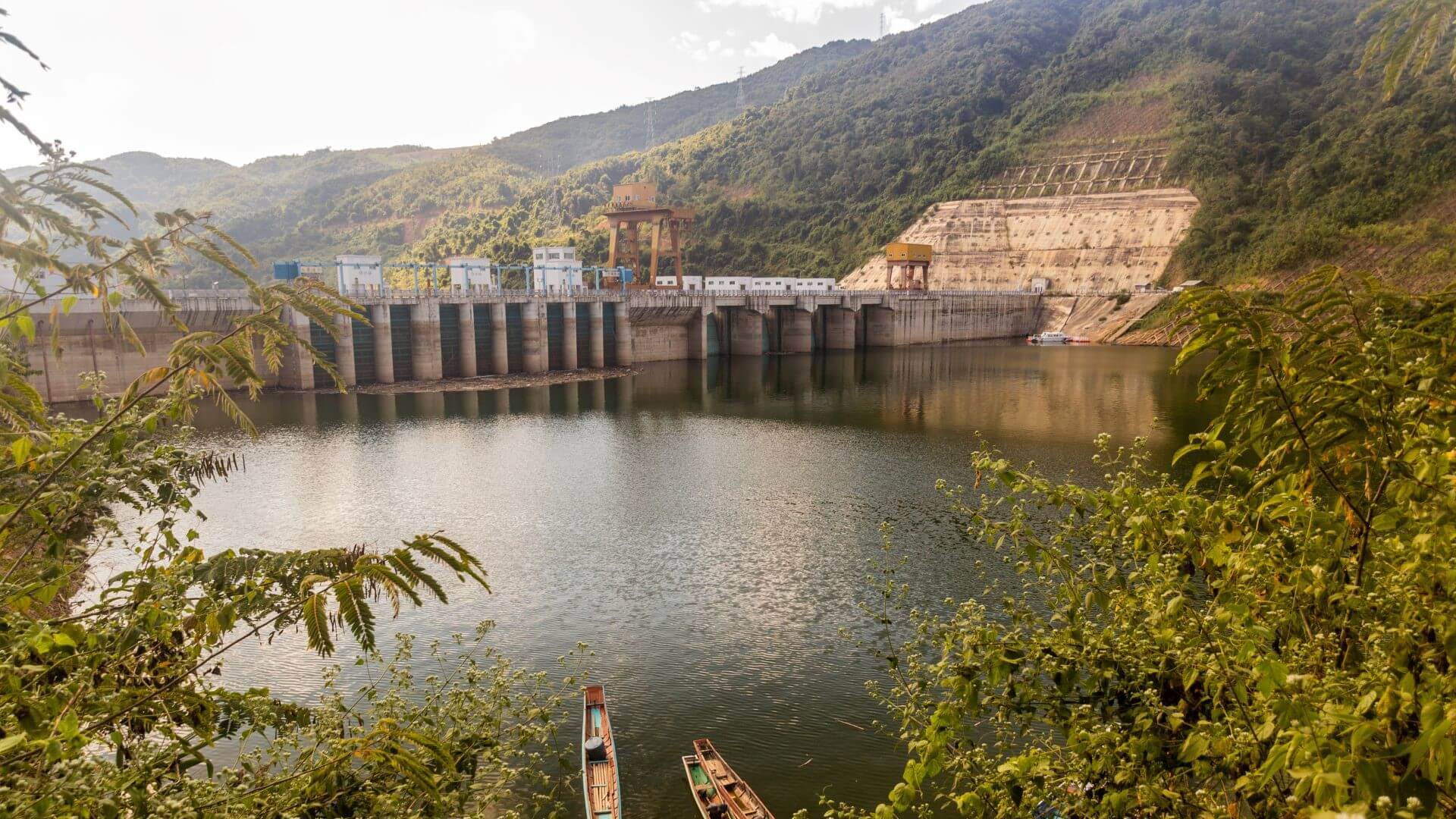 View across reservoir overlooking dam with hills behind
