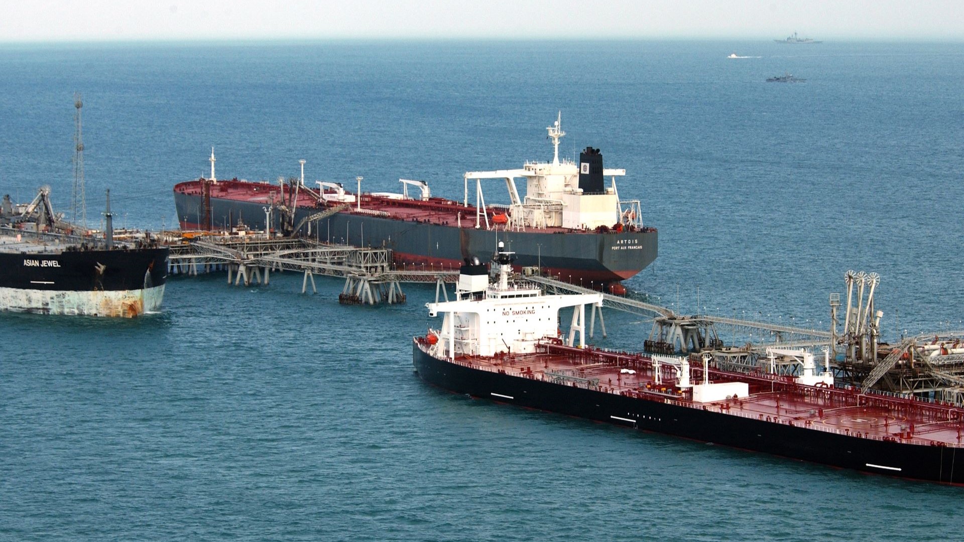 Close aerial photograph of three oil tankers in calm blue sea