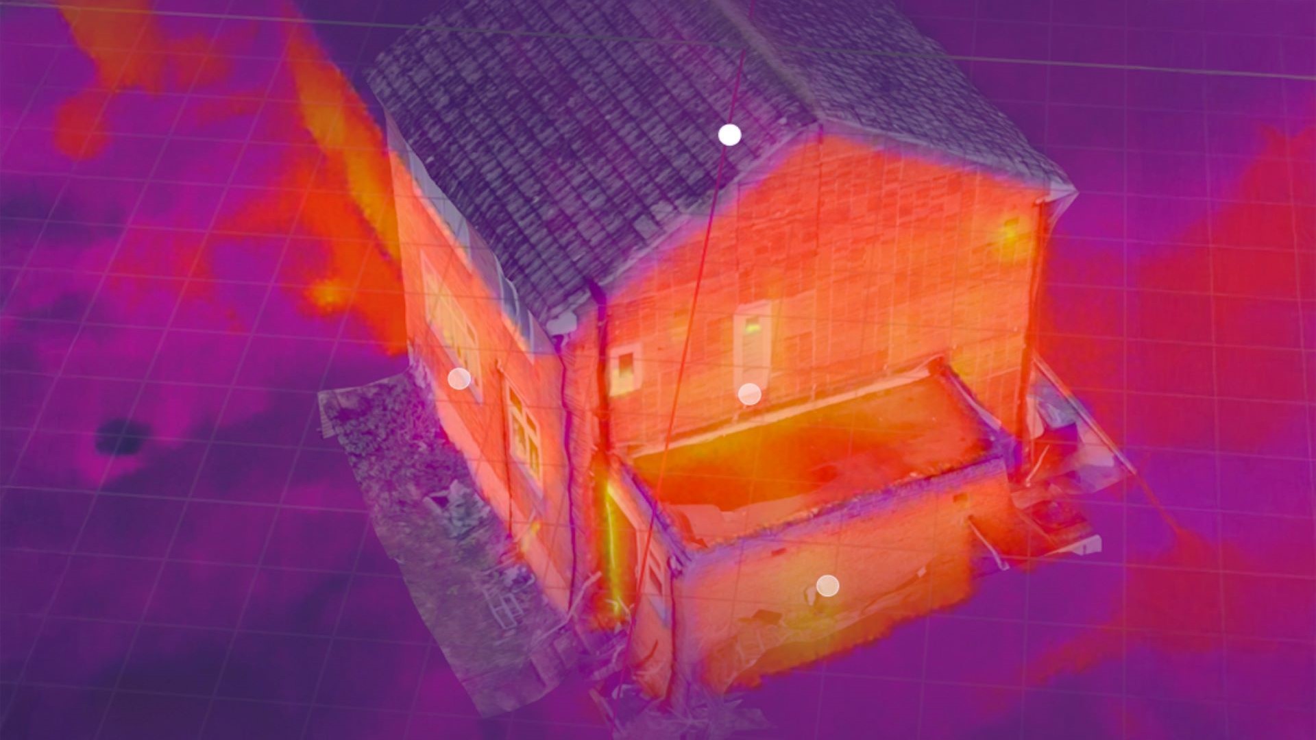 Thermal camera's aerial view over residential house showing bright orange and yellow colours where heat is being lost to the atmosphere
