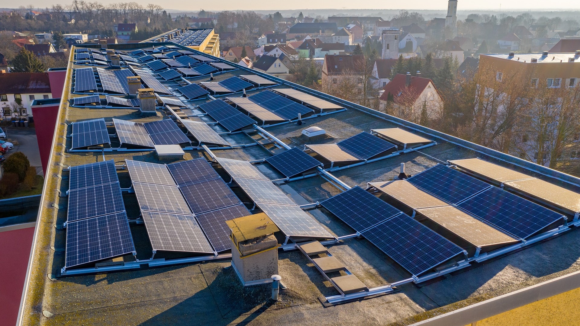 Close up of rows of rooftop solar panels extending into distance