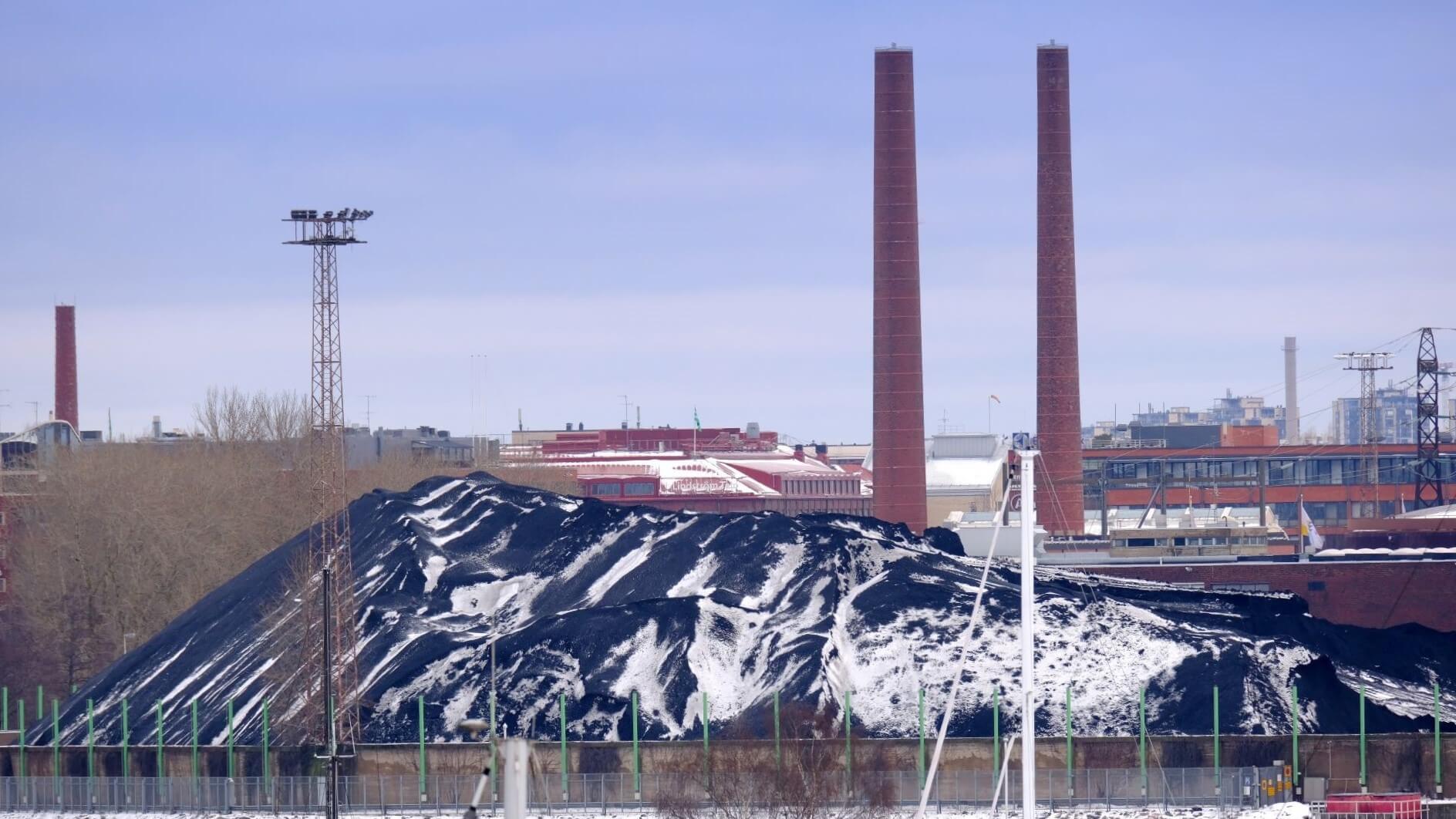 Salmisaari coal power plant with pile of coal in foreground