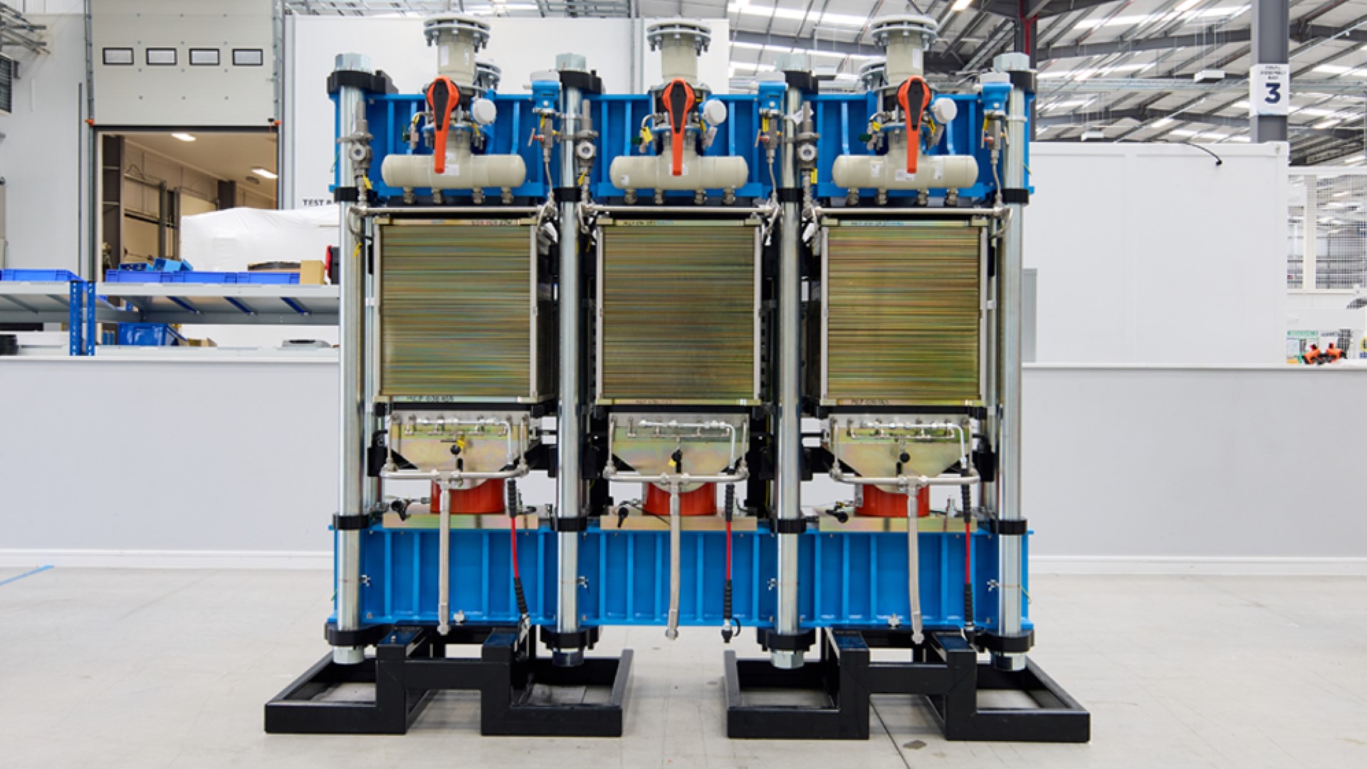 Electrolyser unit showing internal workings, standing on building floor