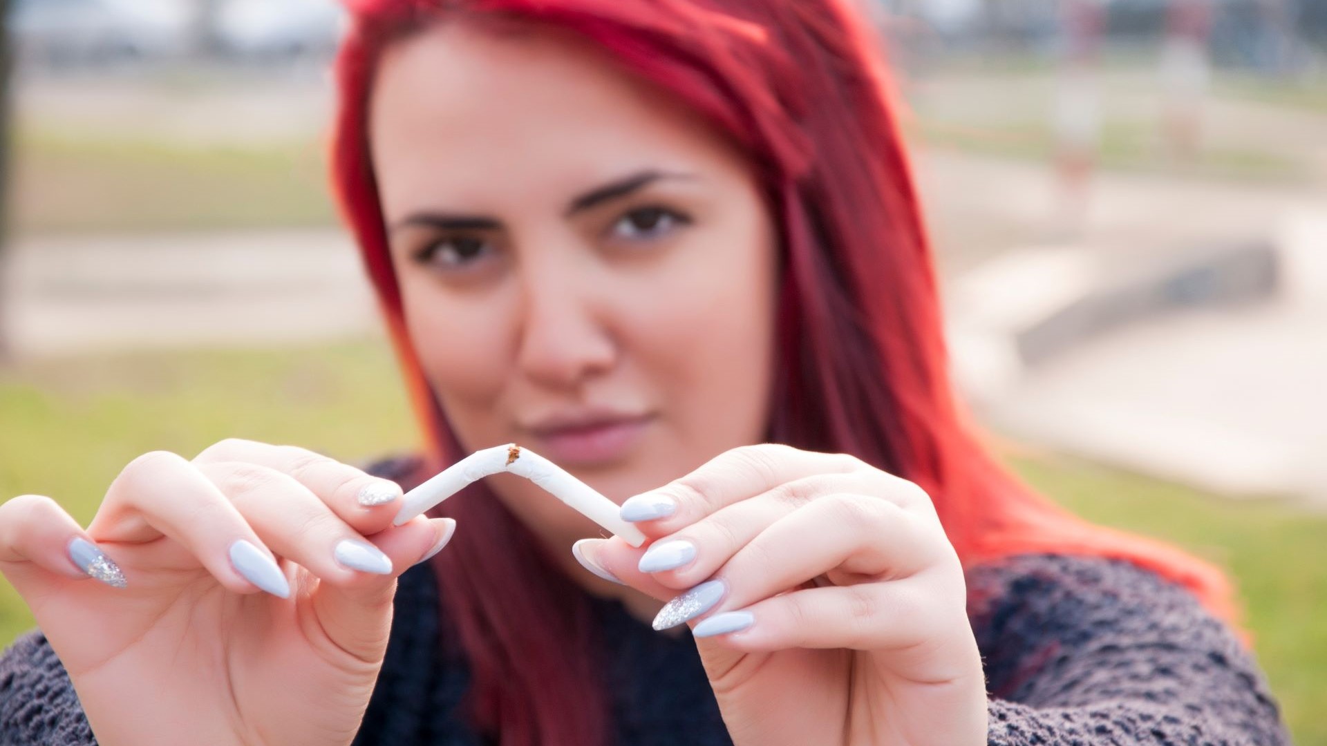 A person breaking a cigarette