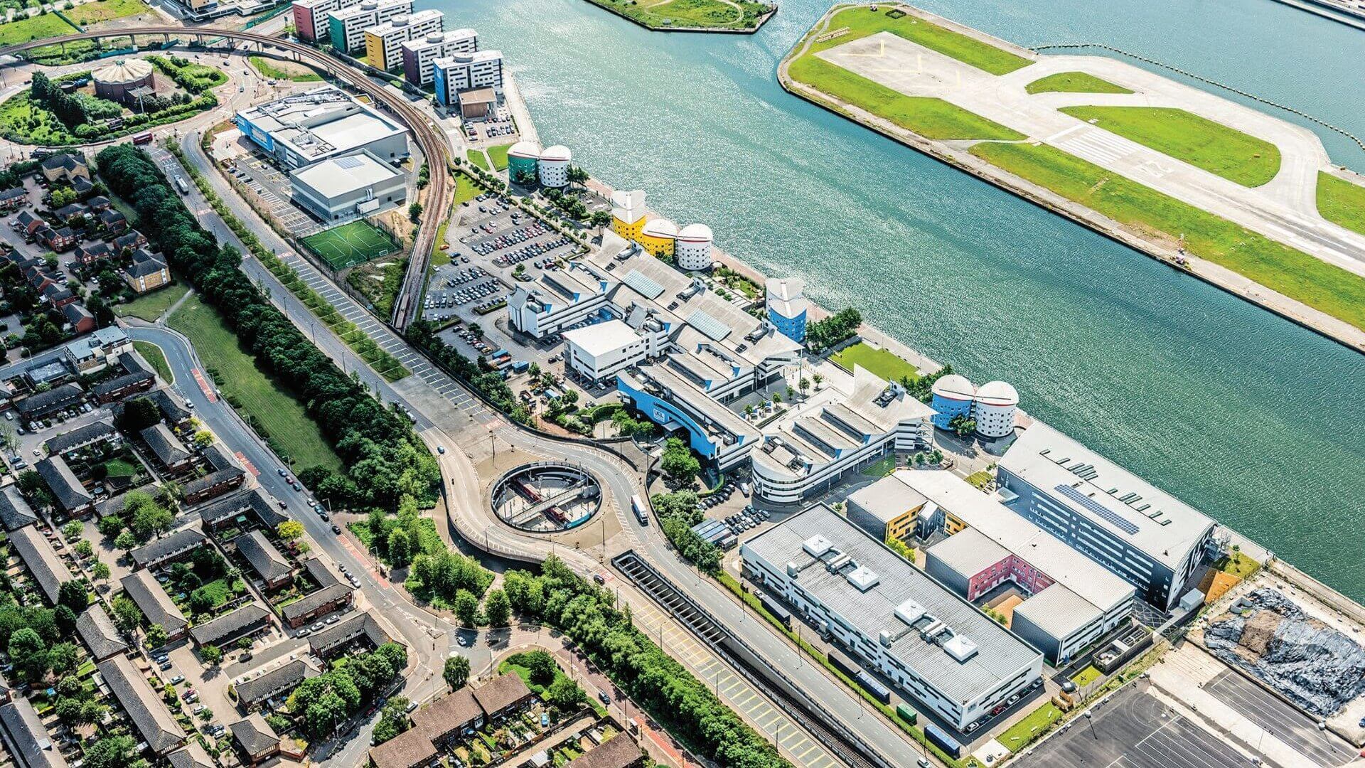 Aerial view of the University of East London in London’s Docklands, showing lots of buildings and tower blocks alongside river