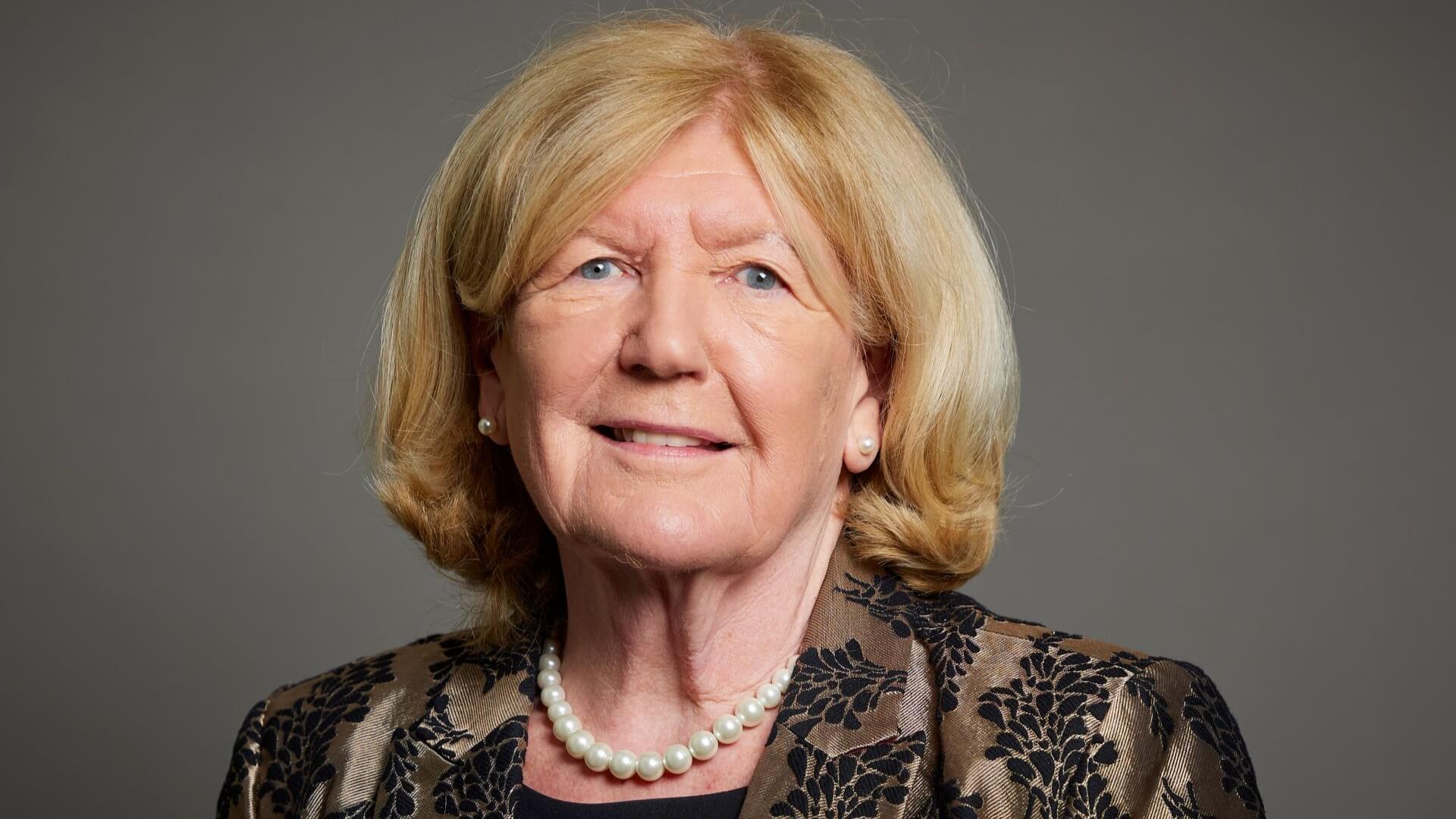 Head and shoulders photo of Baroness Taylor of Bolton against dark grey background