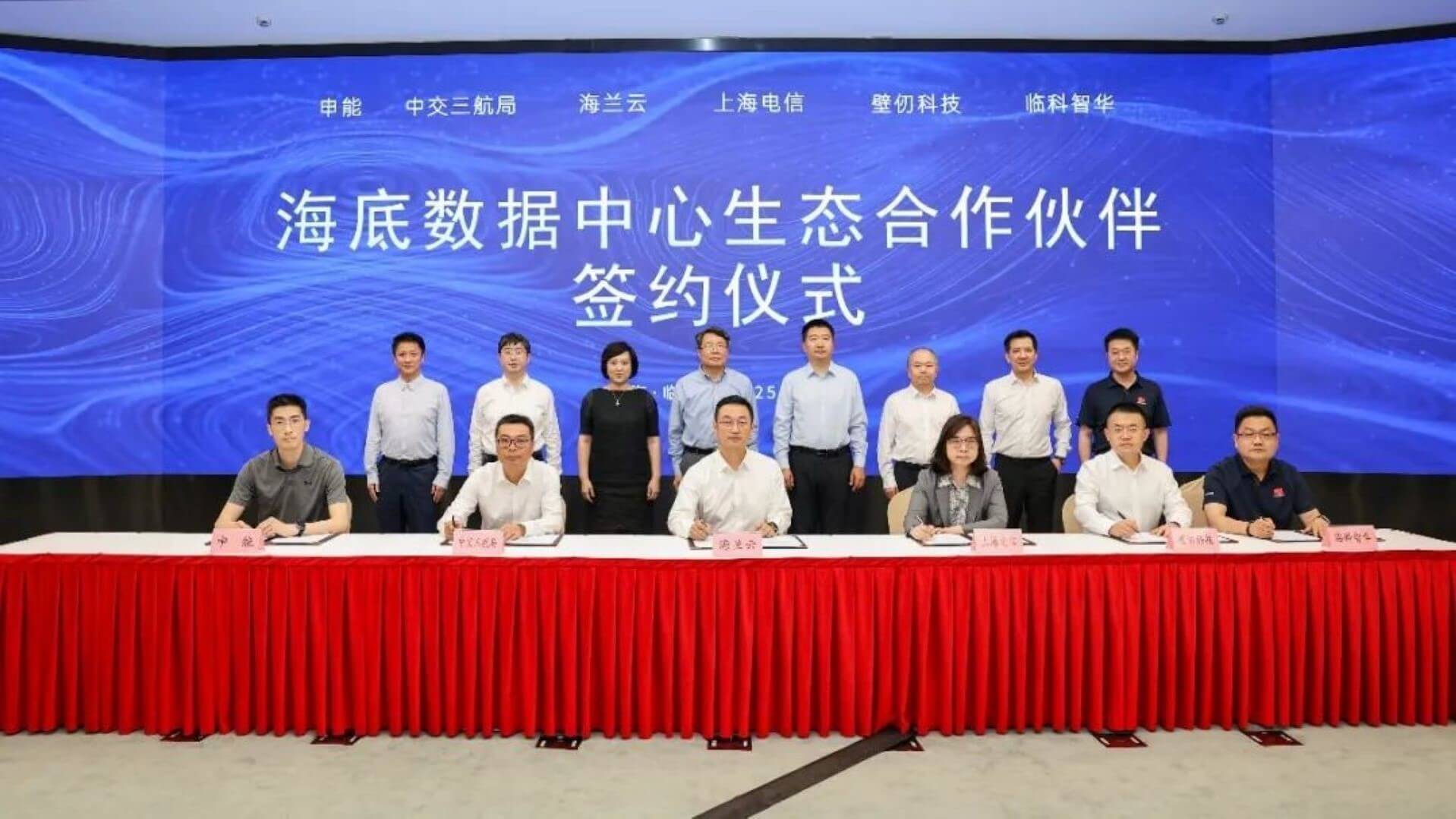 A group of people at a table during signing ceremony