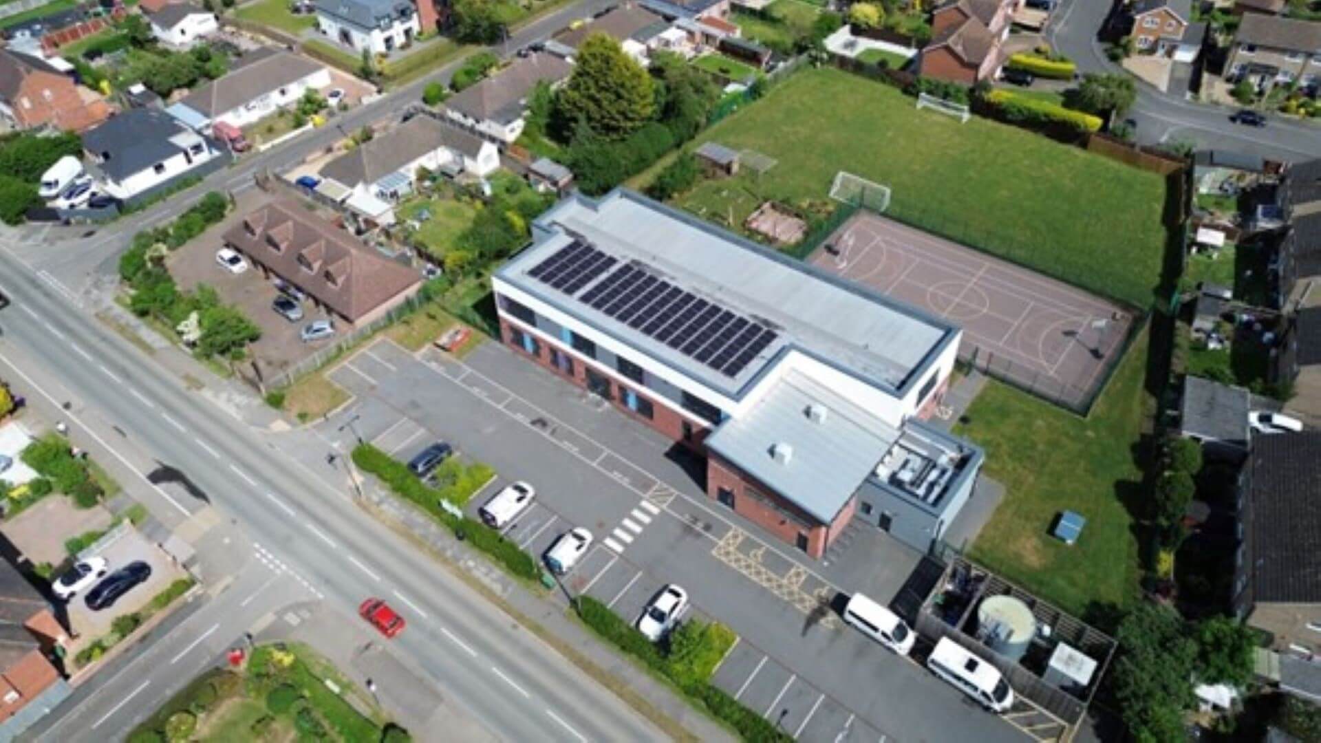 Aerial view of building with solar panels on the roof
