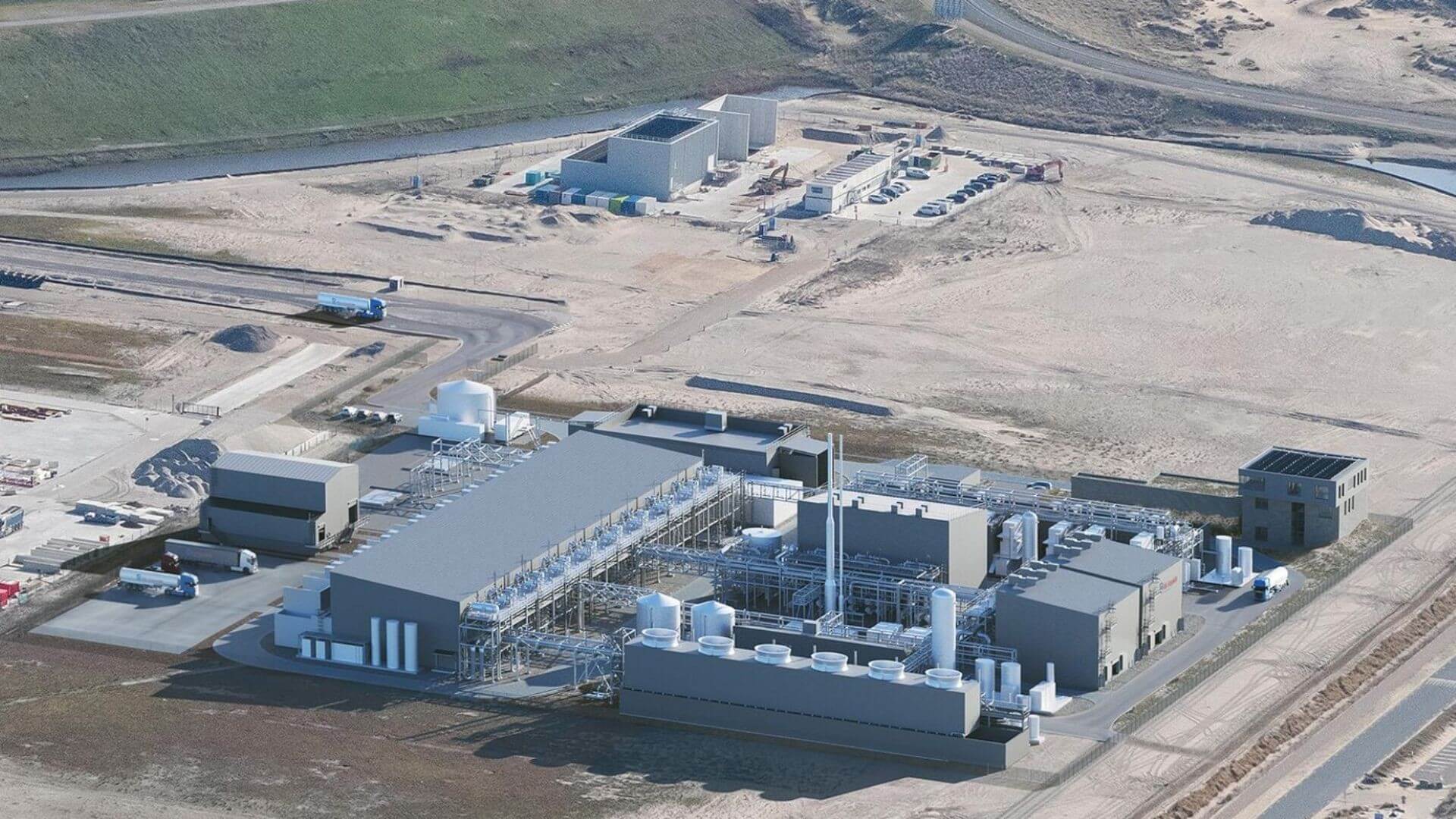 Aerial overview of industrial plant buildings and storage tanks