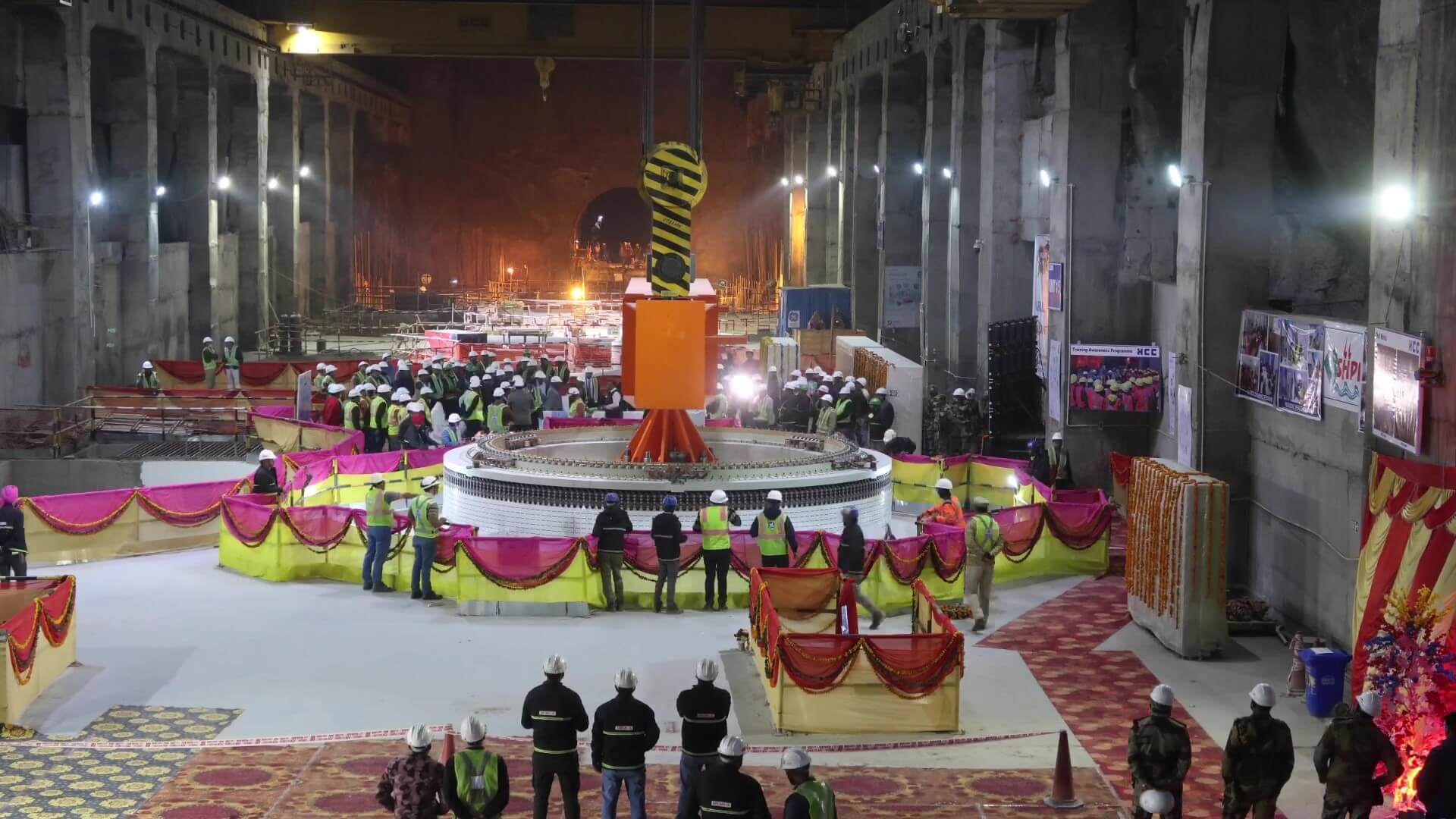 Lots of people standing around industrial equipment at an inauguration ceremony