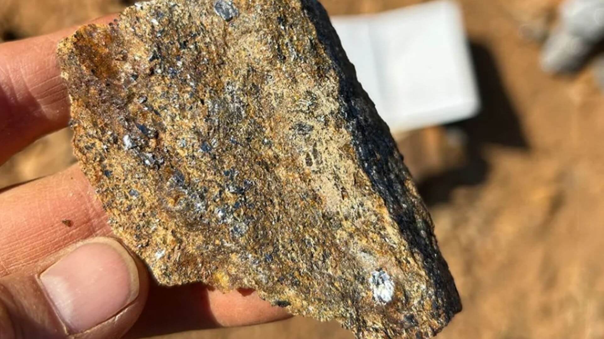A hand holding a rock