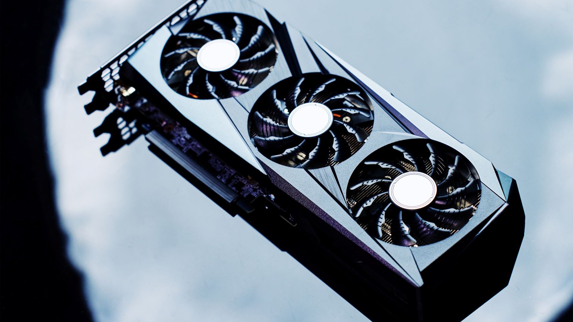 Close up photo of a rectangular computer processing unit with a row of three circular fans