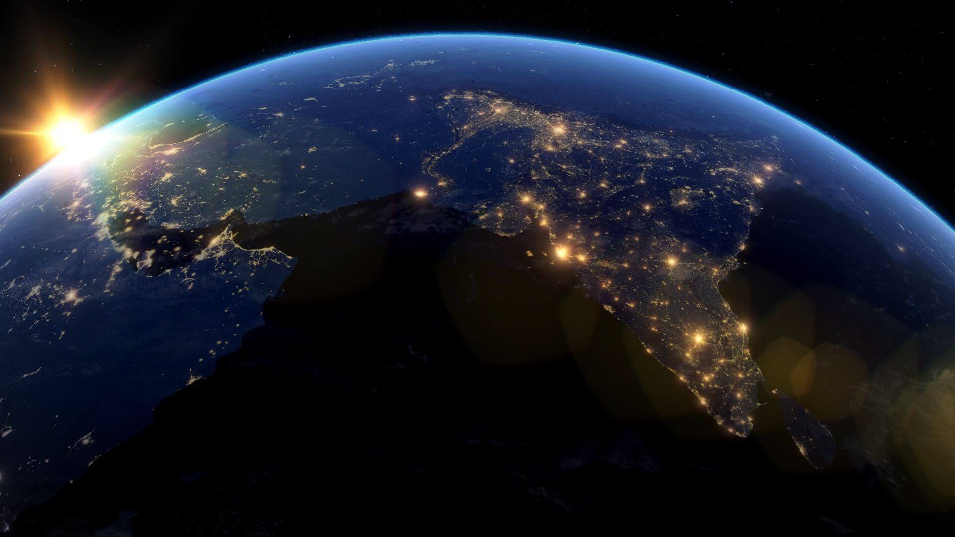 Computer generated 3D drawing of NASA satellite photo of the globe, with the sun rising over India