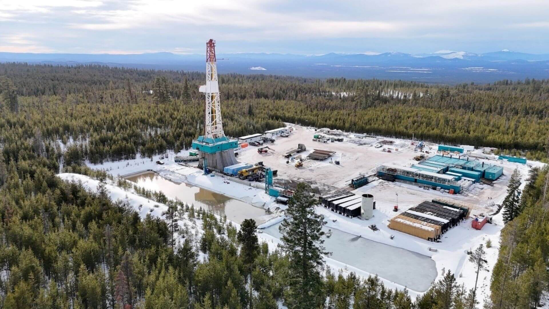 Aerial view of a drilling site in the middle of a forest