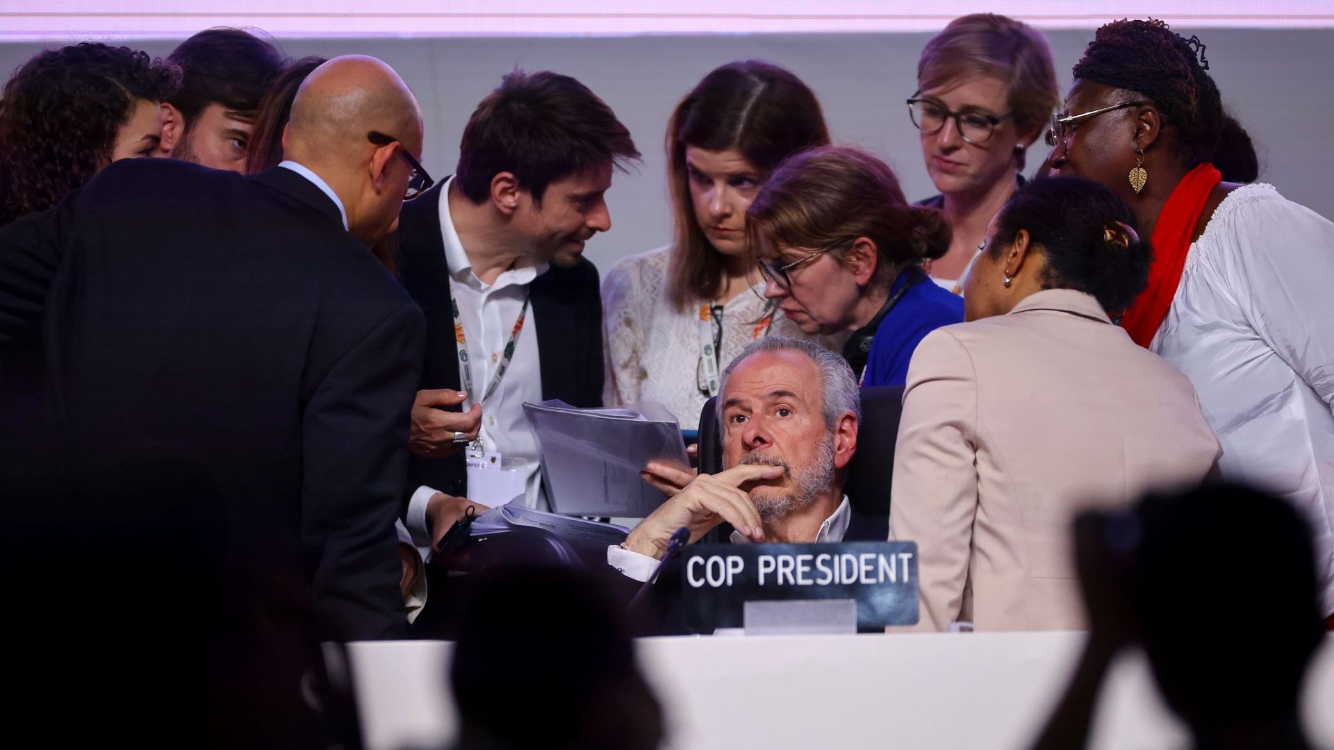 Group of people surrounding COP30 President Andre Correa