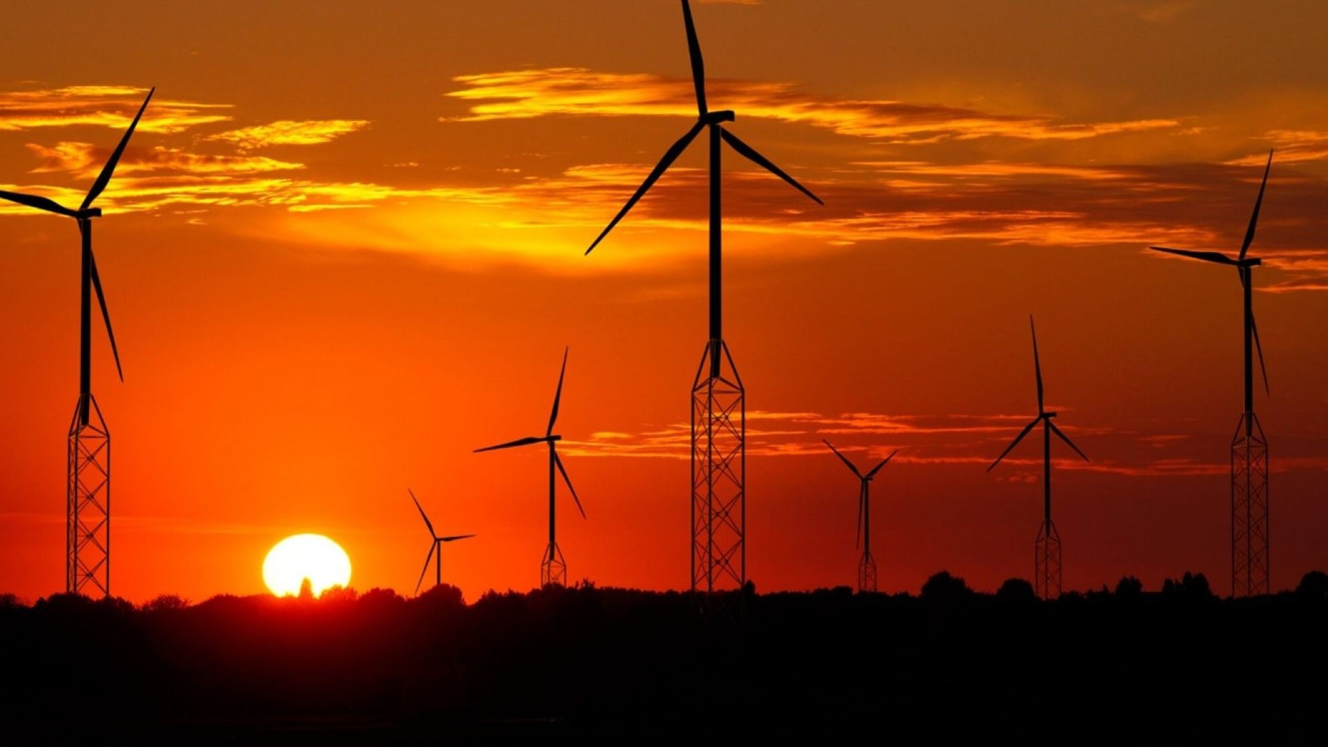 Onshore wind farm with self-erecting tower technology at sunset