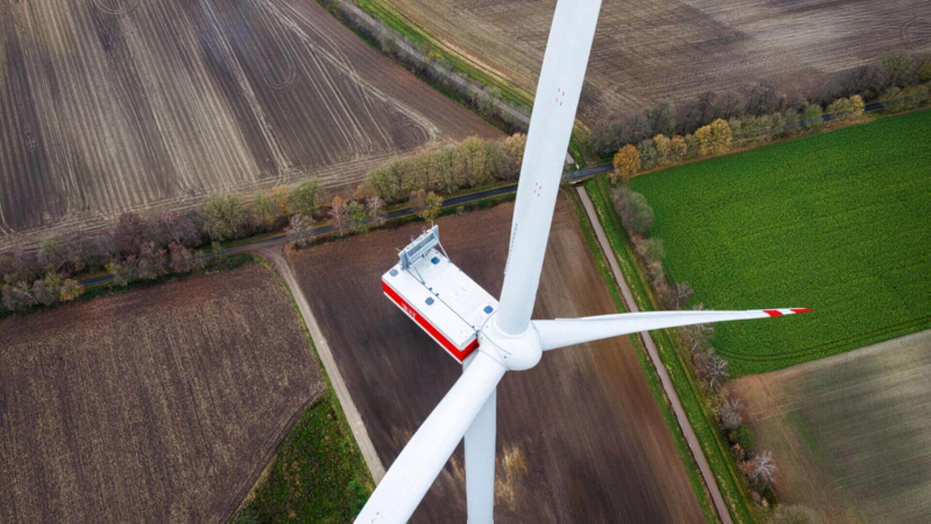 Aerial view of wind turbine in field