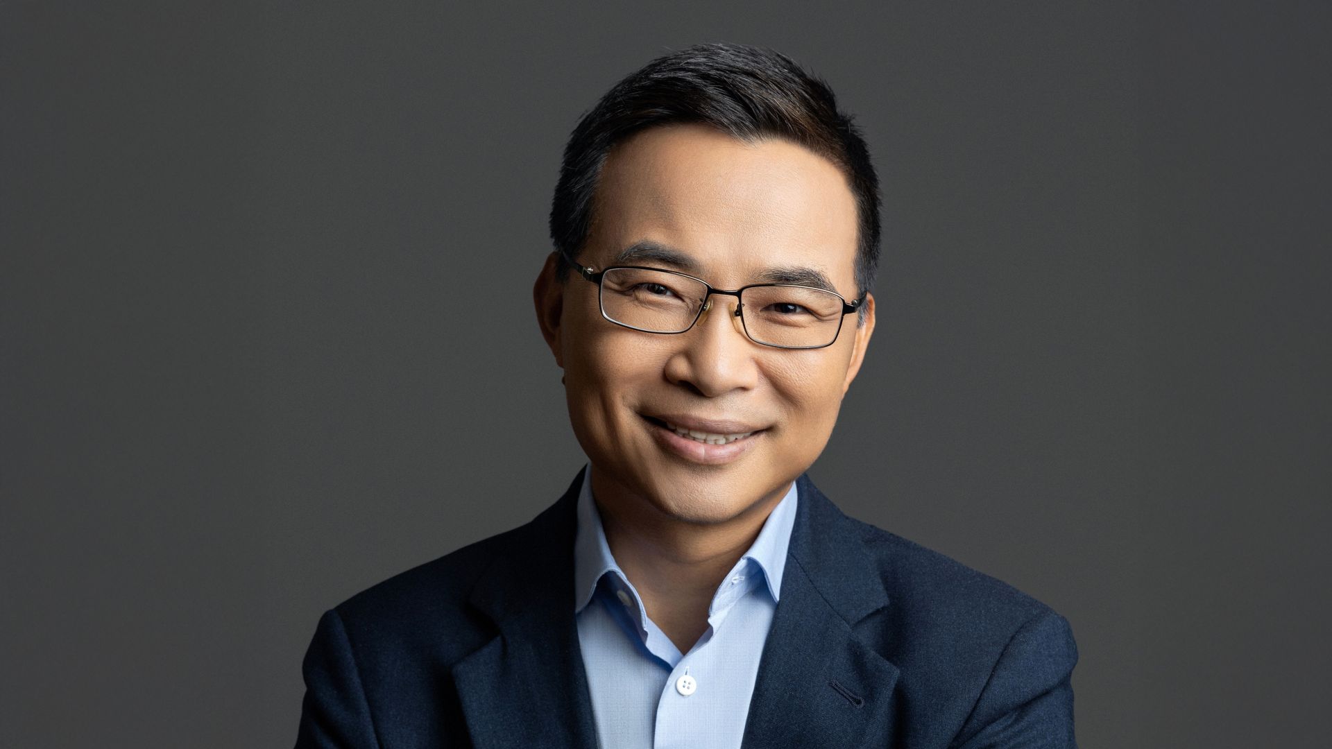 Head and shoulders photo of Lei Zhang against a dark grey background