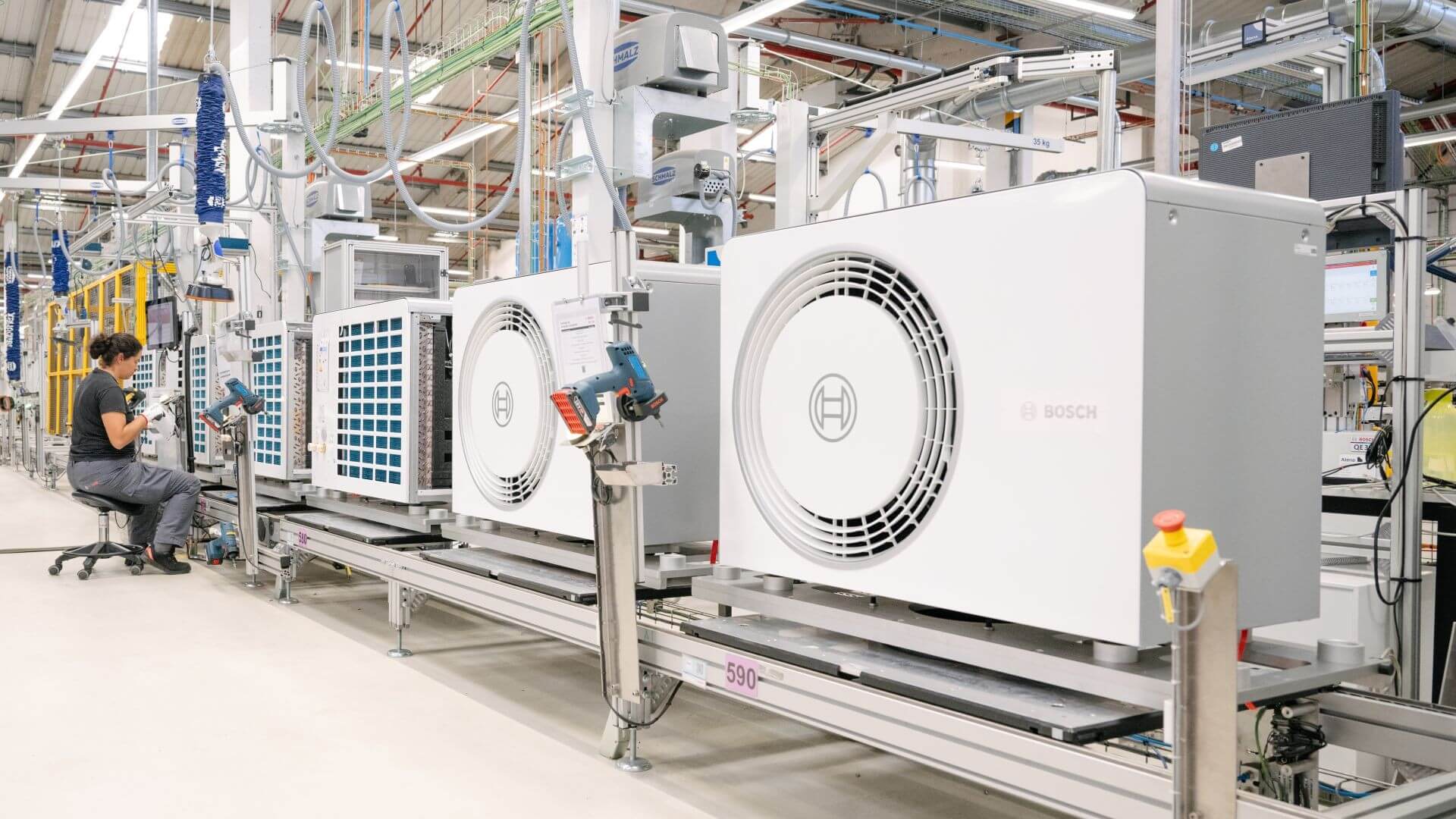 Worker at heat pump production facility