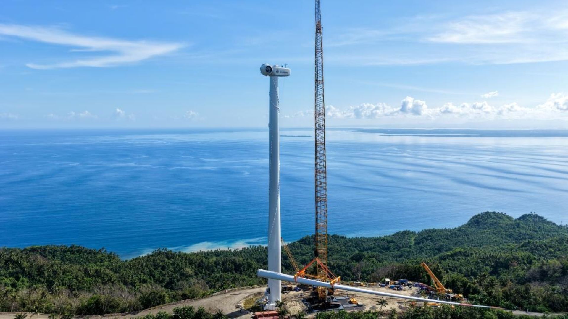 Onshore wind turbine under construction near coast