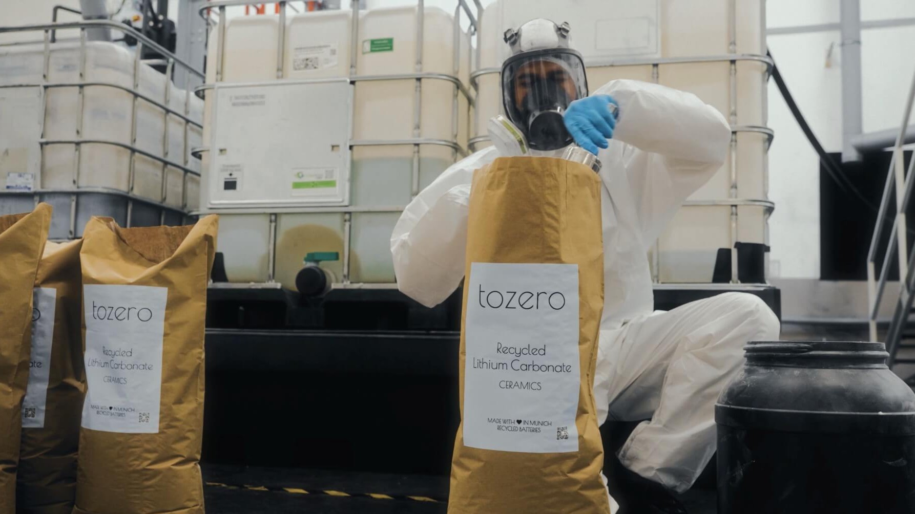 Worker filling bag of recycled lithium carbonate in factory