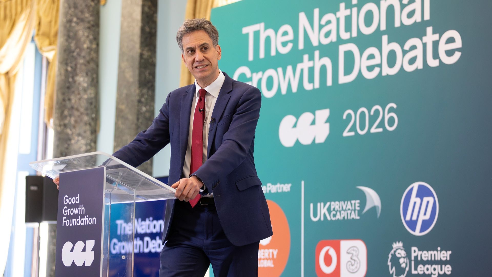 Ed Miliband giving speech while standing behind lecturn and microphone