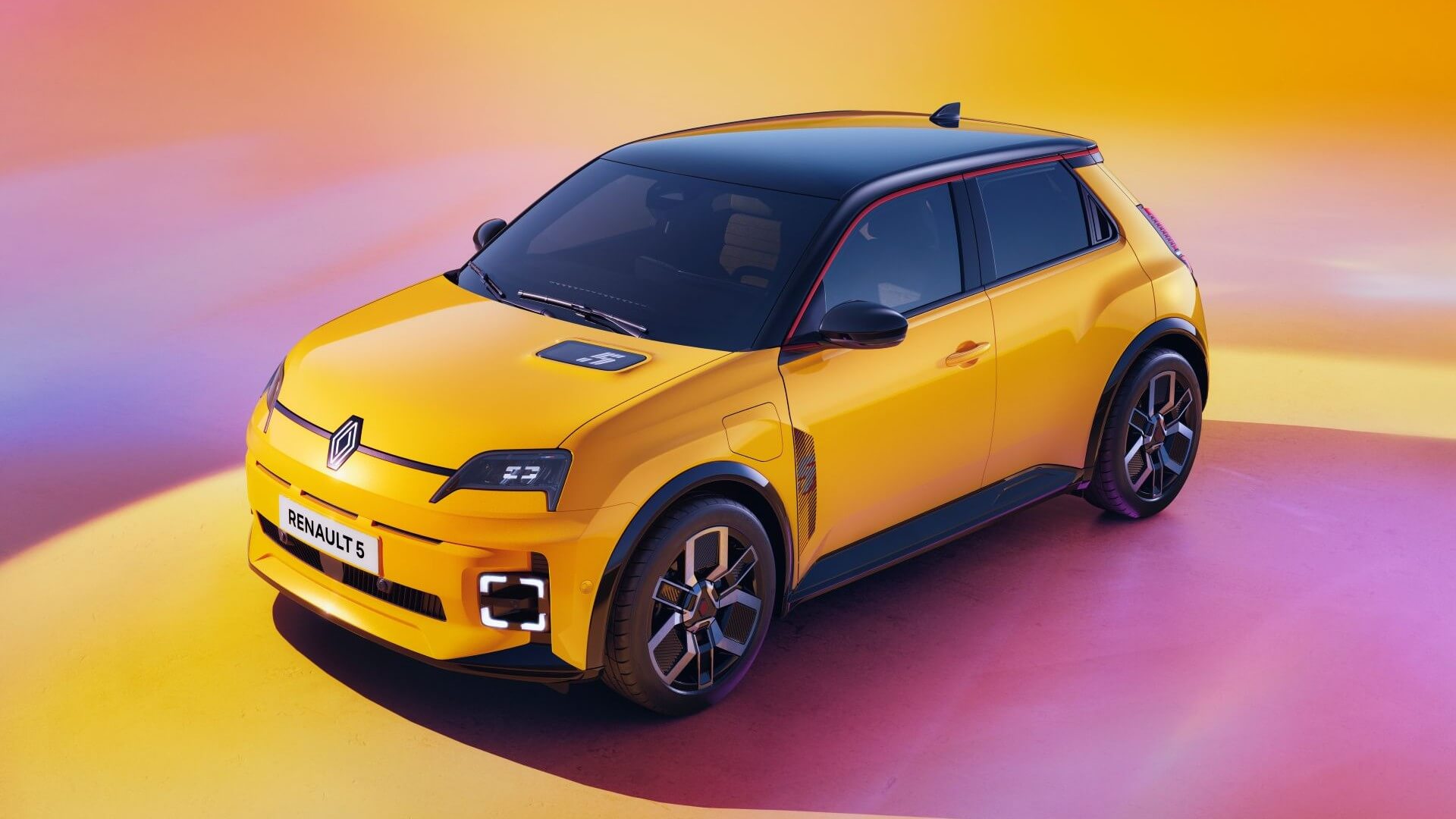 Photo of bright yellow car, with black tinted windows and black roof, parked on a floor with large pink circle and yellow surround, with merged pink and yelllow background