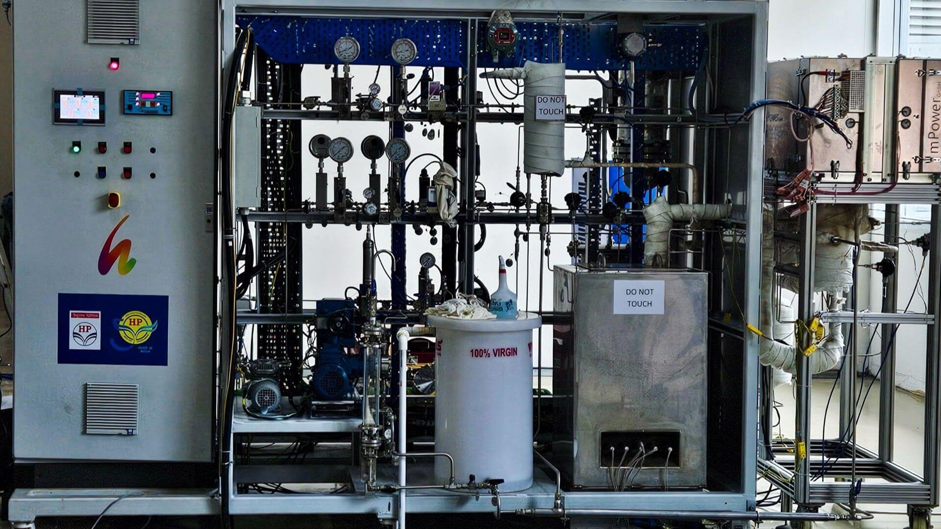 Close up of electrolyer system, showing controls and pipework in a casing