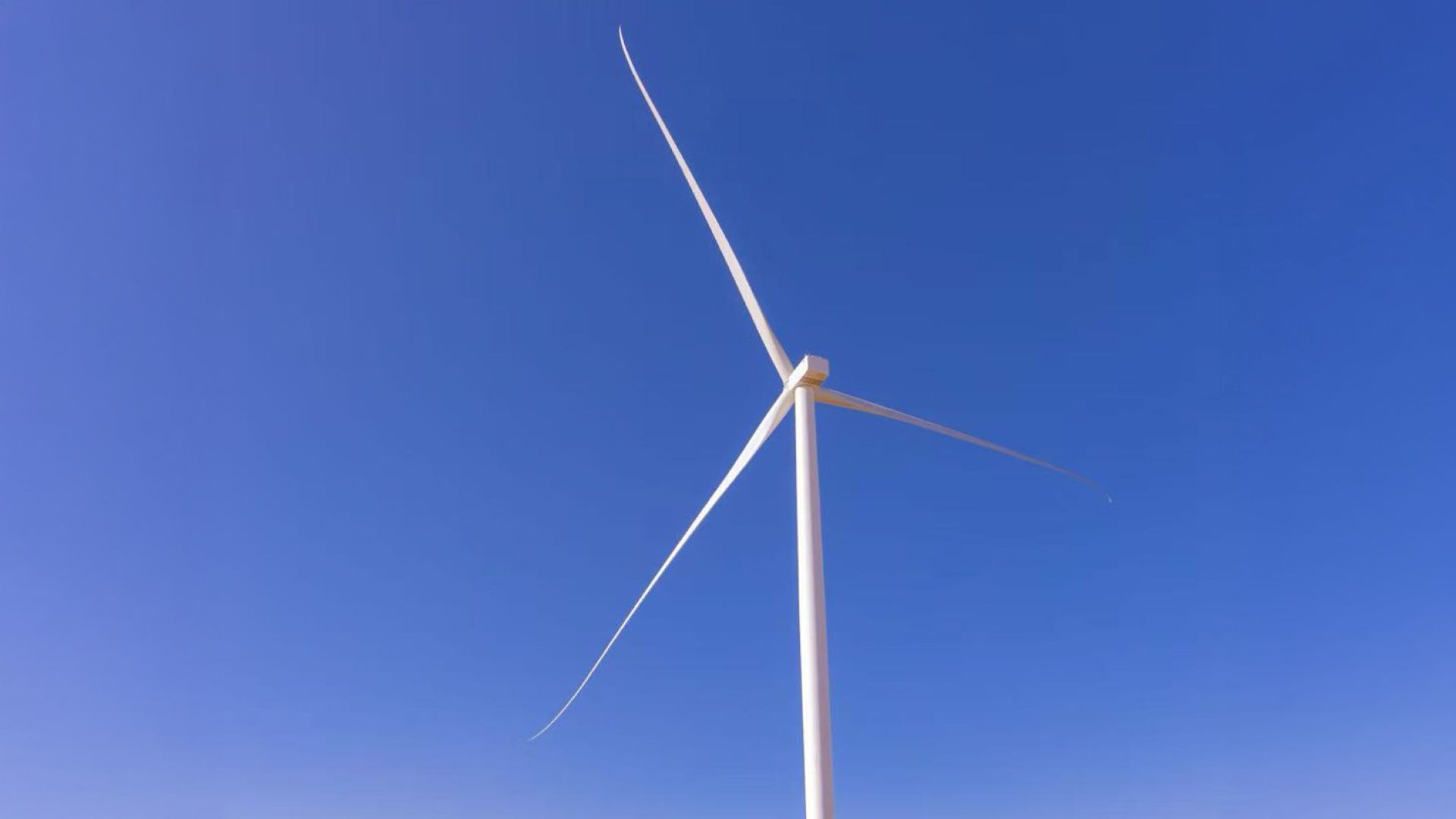 Wind turbine against blue sky