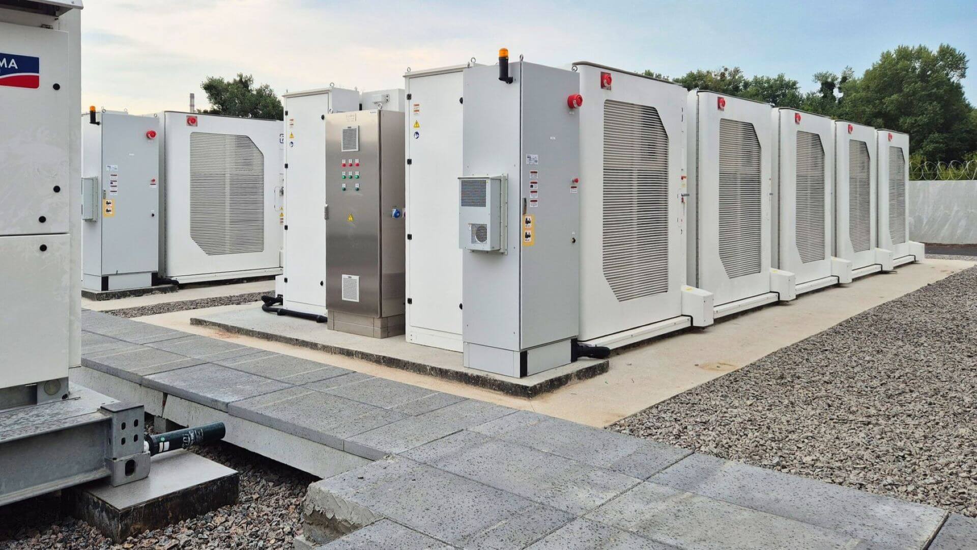 Close up of rows of rectangular battery energy storage systems in lines running diagonally across photo