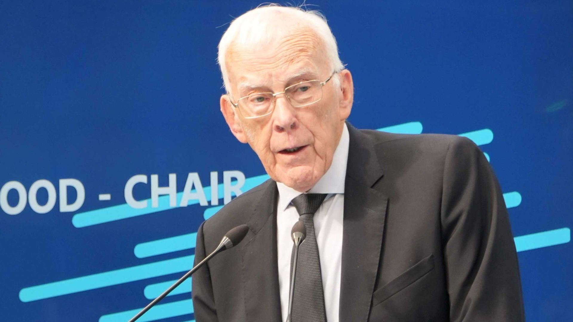 Head and shoulders photo of Sir Ian Wood standing at a lecturn and speaking into microphone at a conference