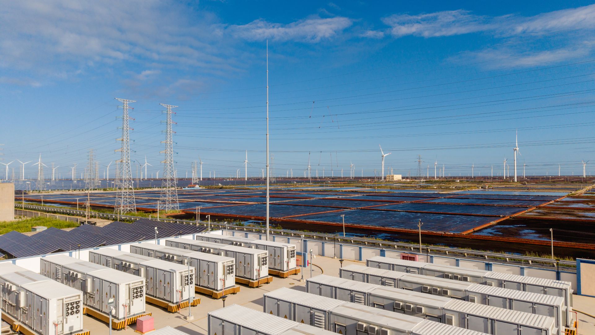 Rows of battery units next to solar farm